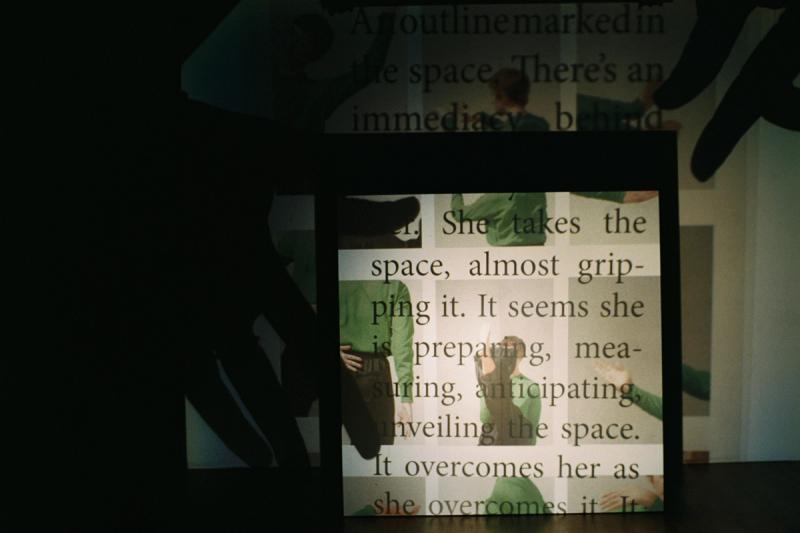 two projection screens with images of a person dancing and words over the top