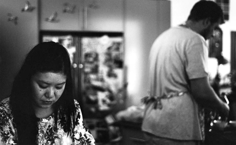 a black and white photo of Aki Yoshida and Jack Mcdonald cooking