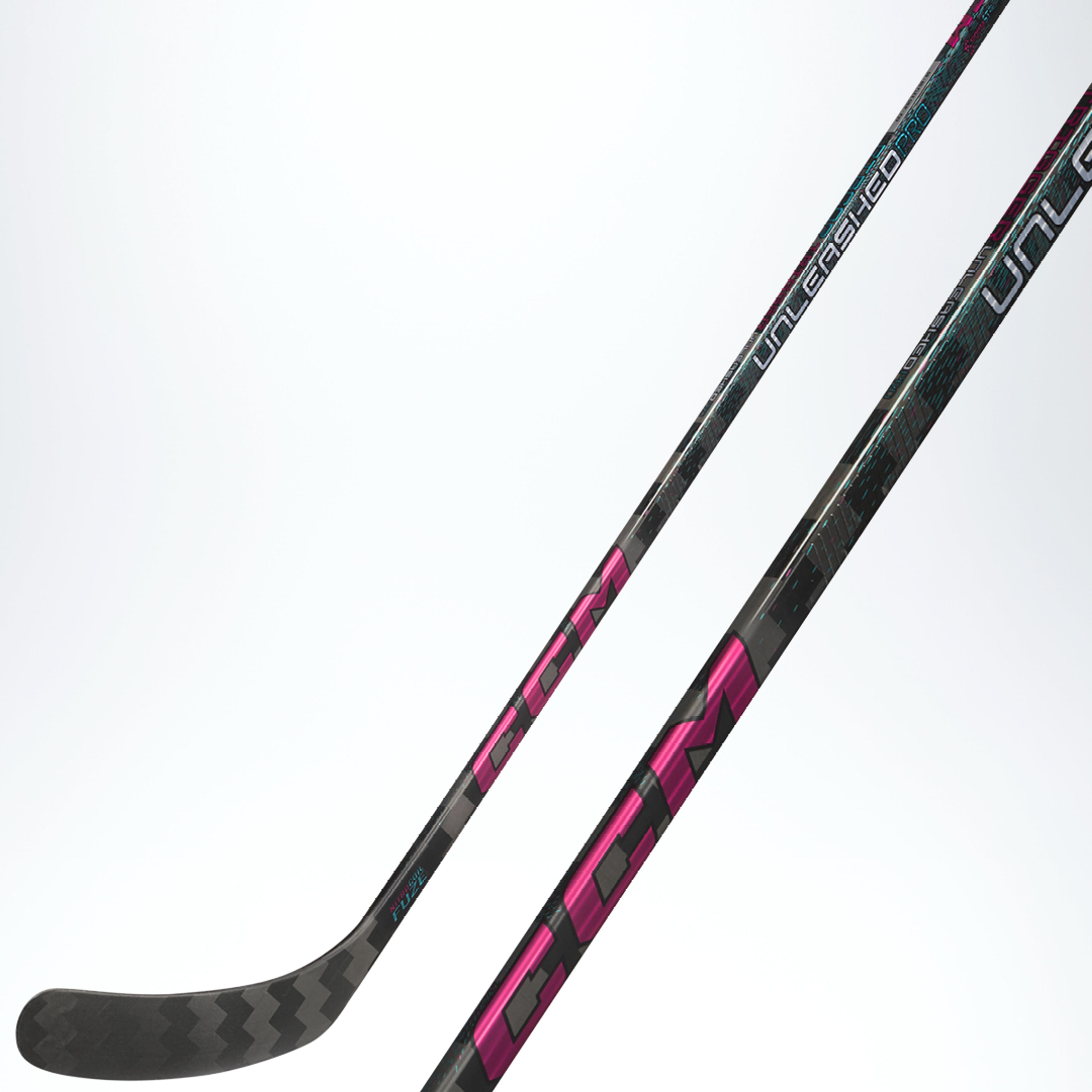 A black CCM hockey stick with pink and teal accents, "UNLEASHED" text, and a chevron pattern on the blade.