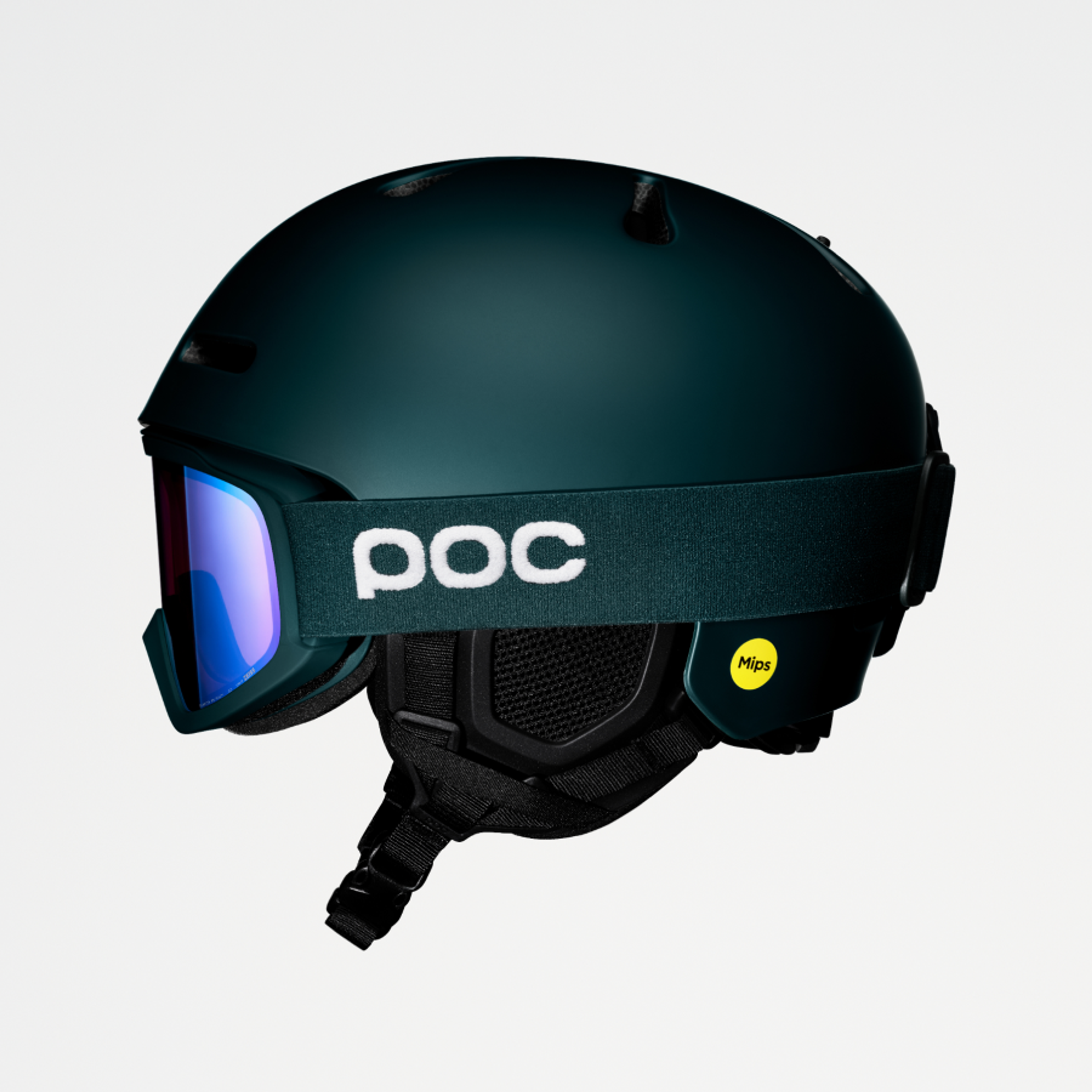 Dark green ski helmet with blue reflective POC goggles and Mips logo.