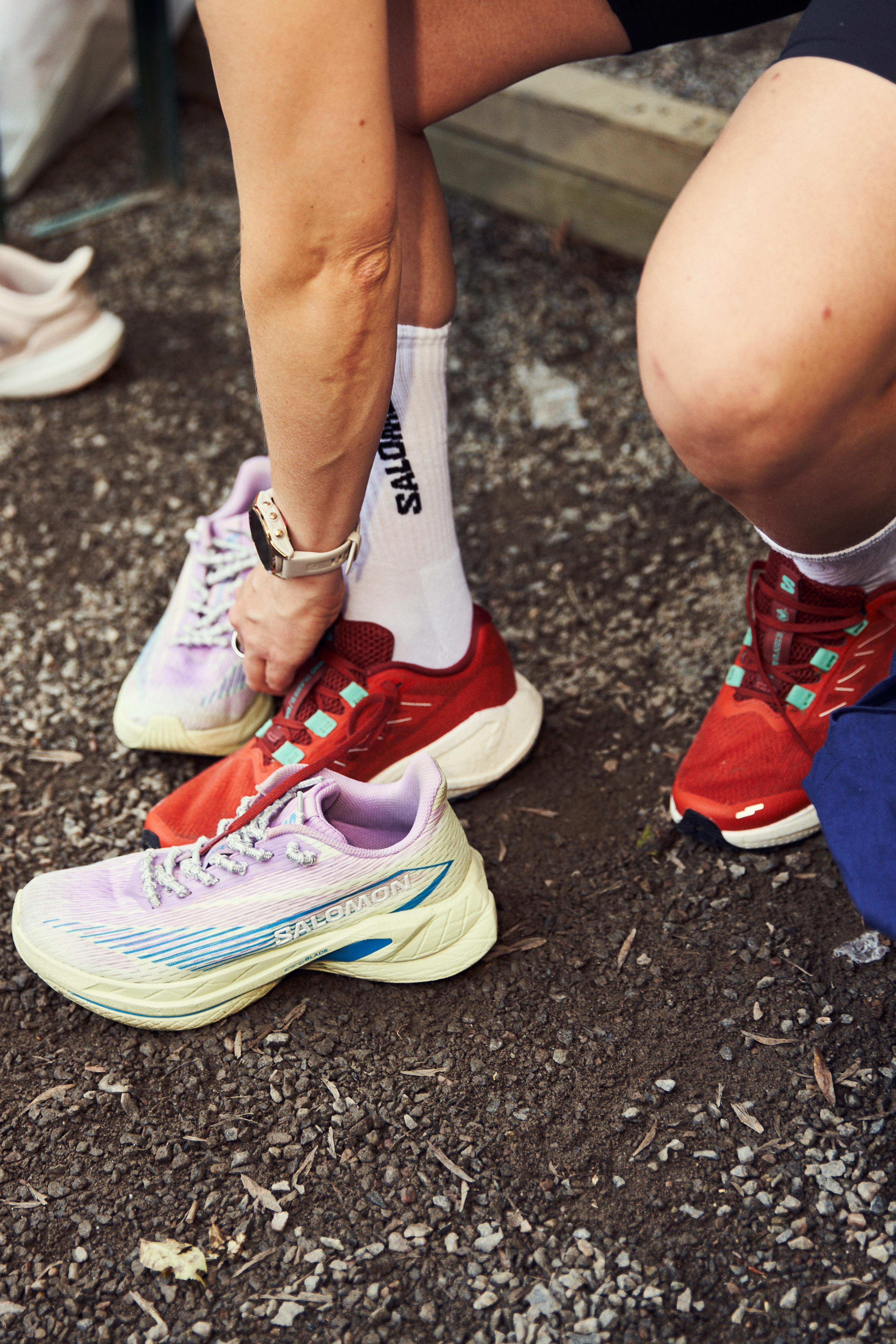 a person wearing a pair of salomon shoes