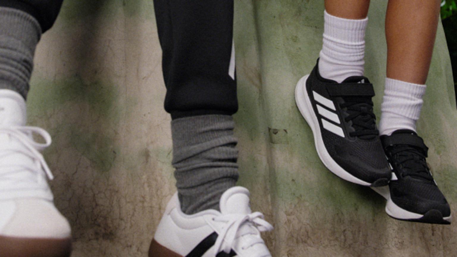 a close up of a person wearing socks and shoes .