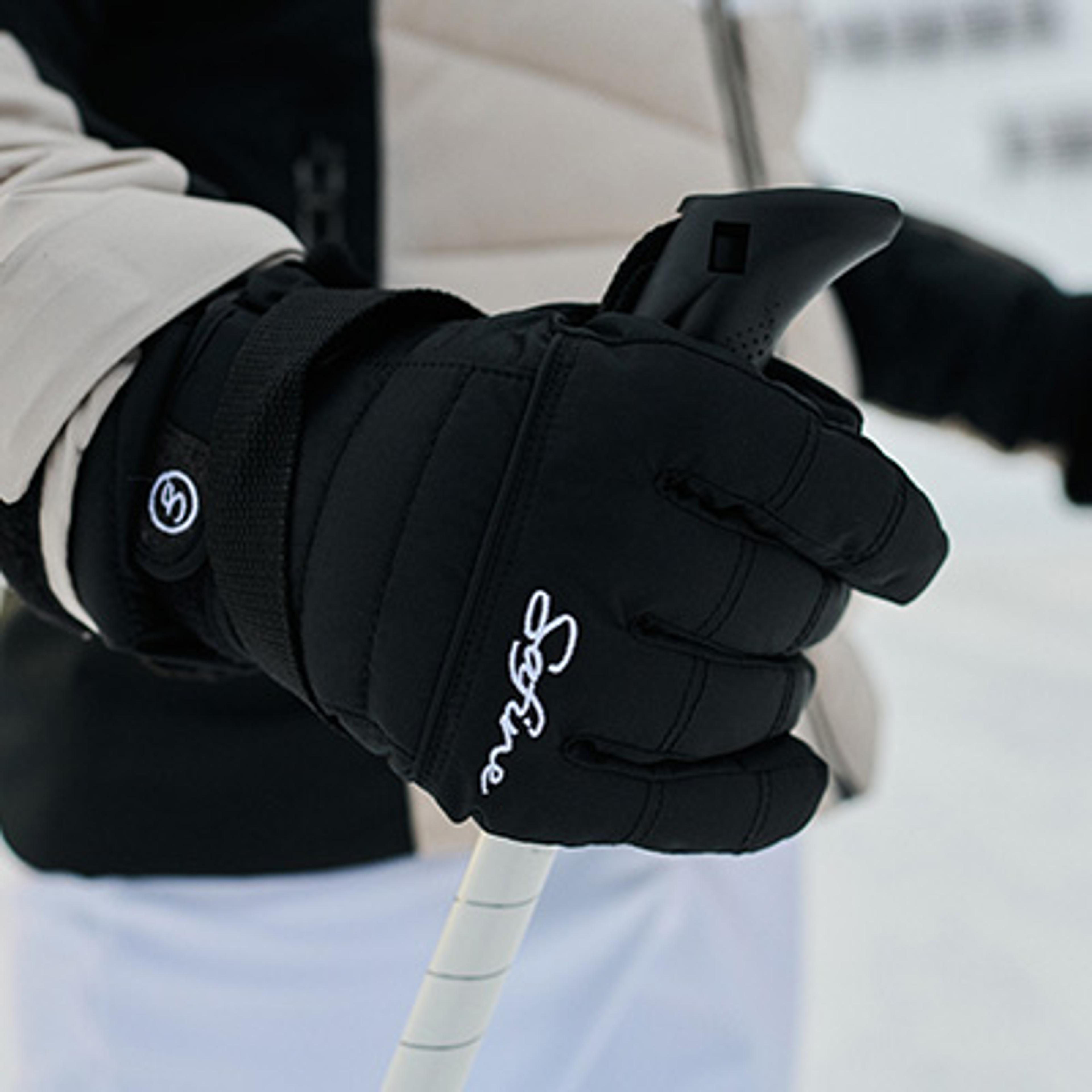 A hand wearing a black "Sabine" branded glove holds a white ski pole.