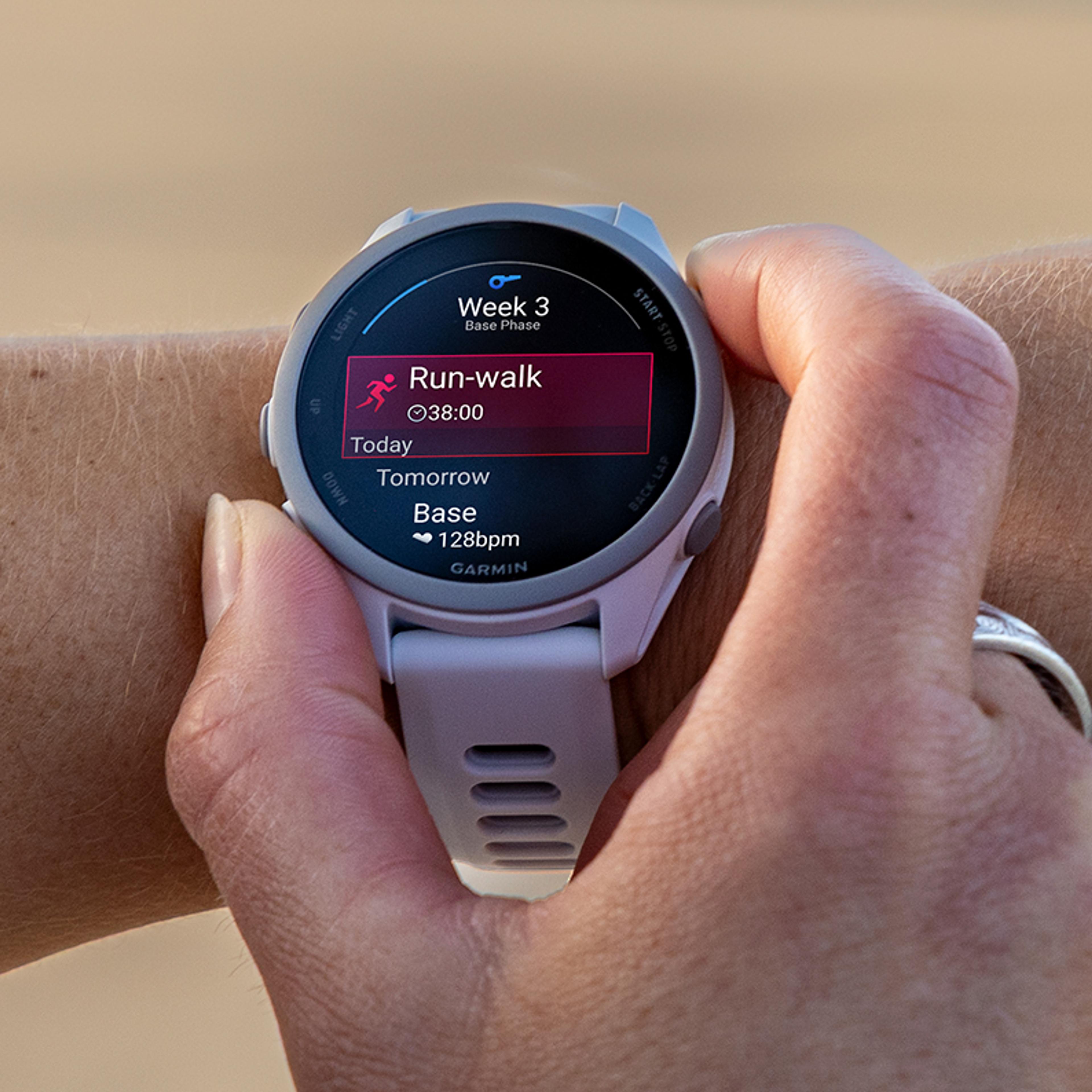 A person's arm wears a white Garmin smartwatch displaying "Run-walk" workout details for 38 minutes.