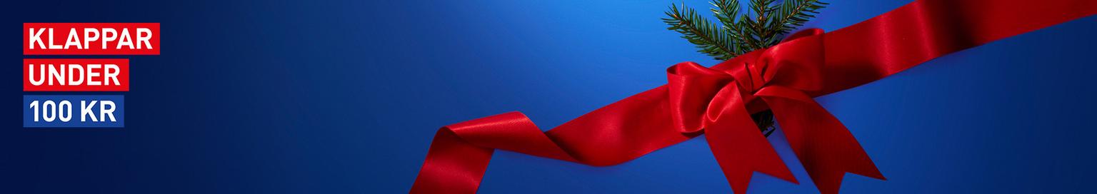 Blue banner with "KLAPPAR UNDER 100 KR" text, a red ribbon bow, and a pine sprig.