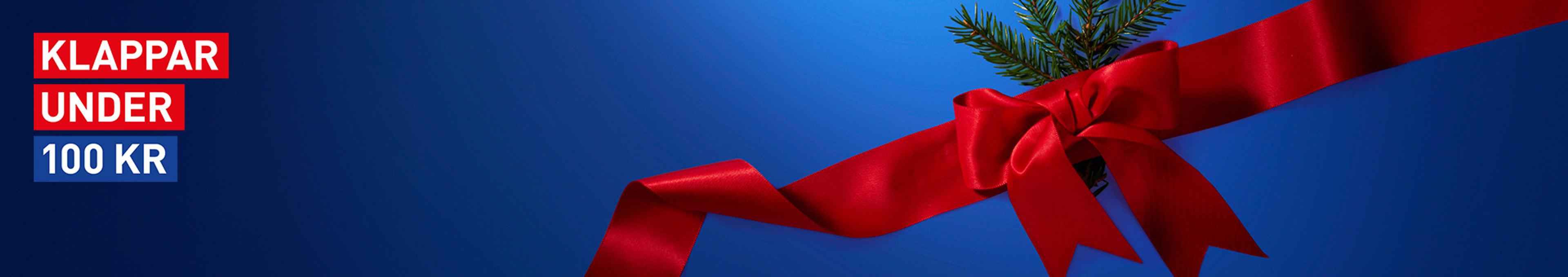 Blue banner with "KLAPPAR UNDER 100 KR" text, a red ribbon bow, and a pine sprig.