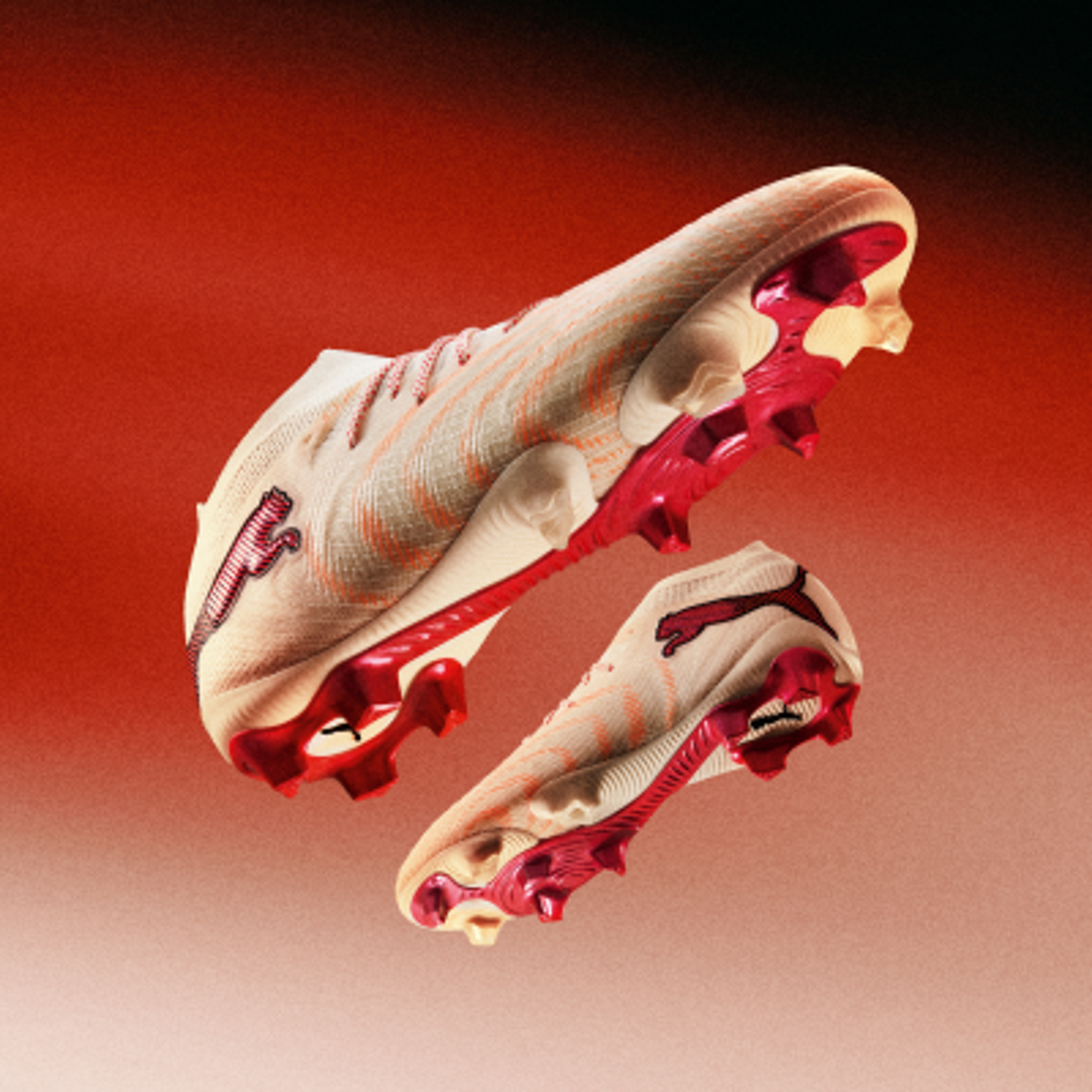Two off-white and red Puma soccer cleats floating against a red gradient background.