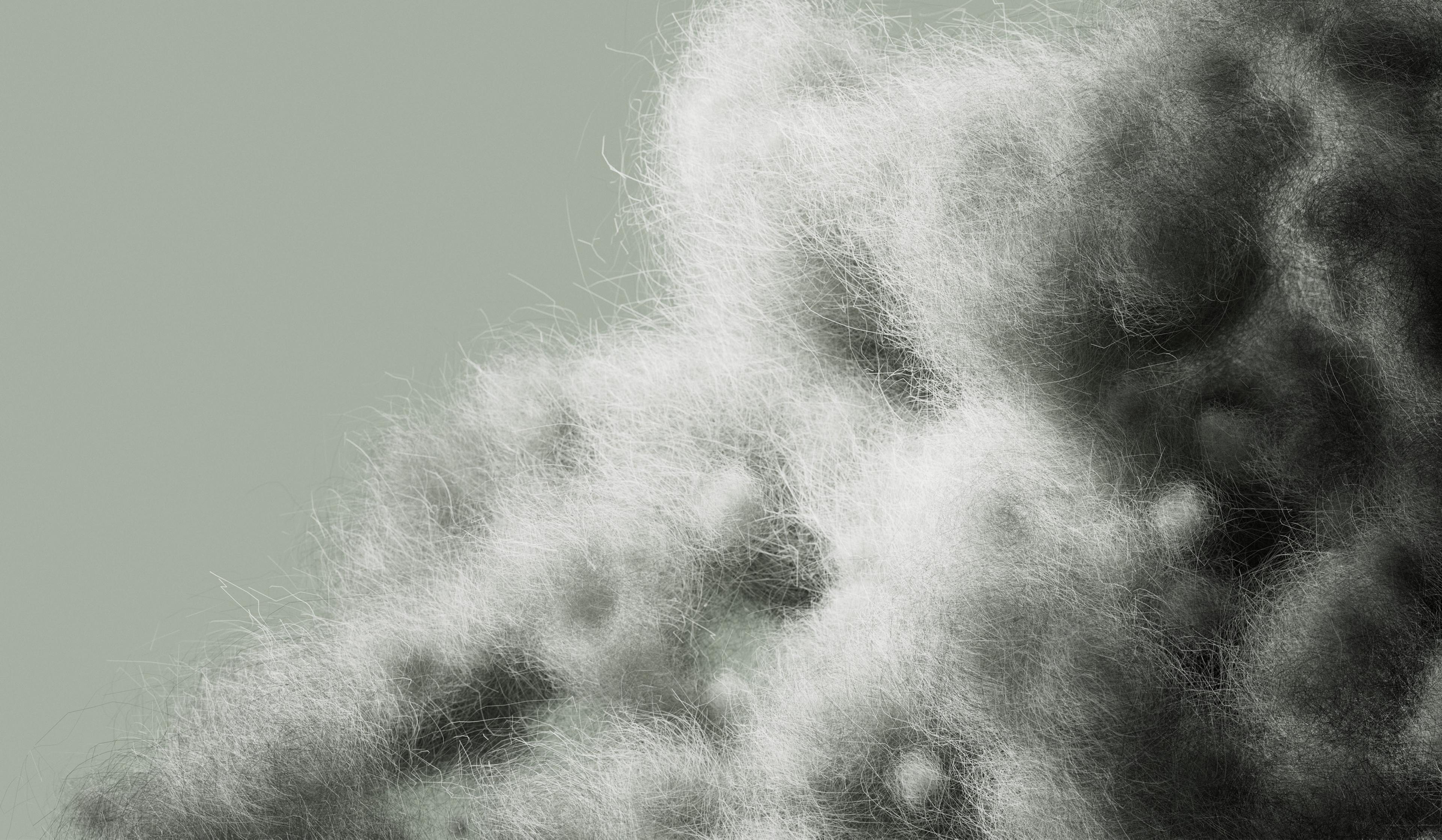 a close up of a pile of wool on a gray background .