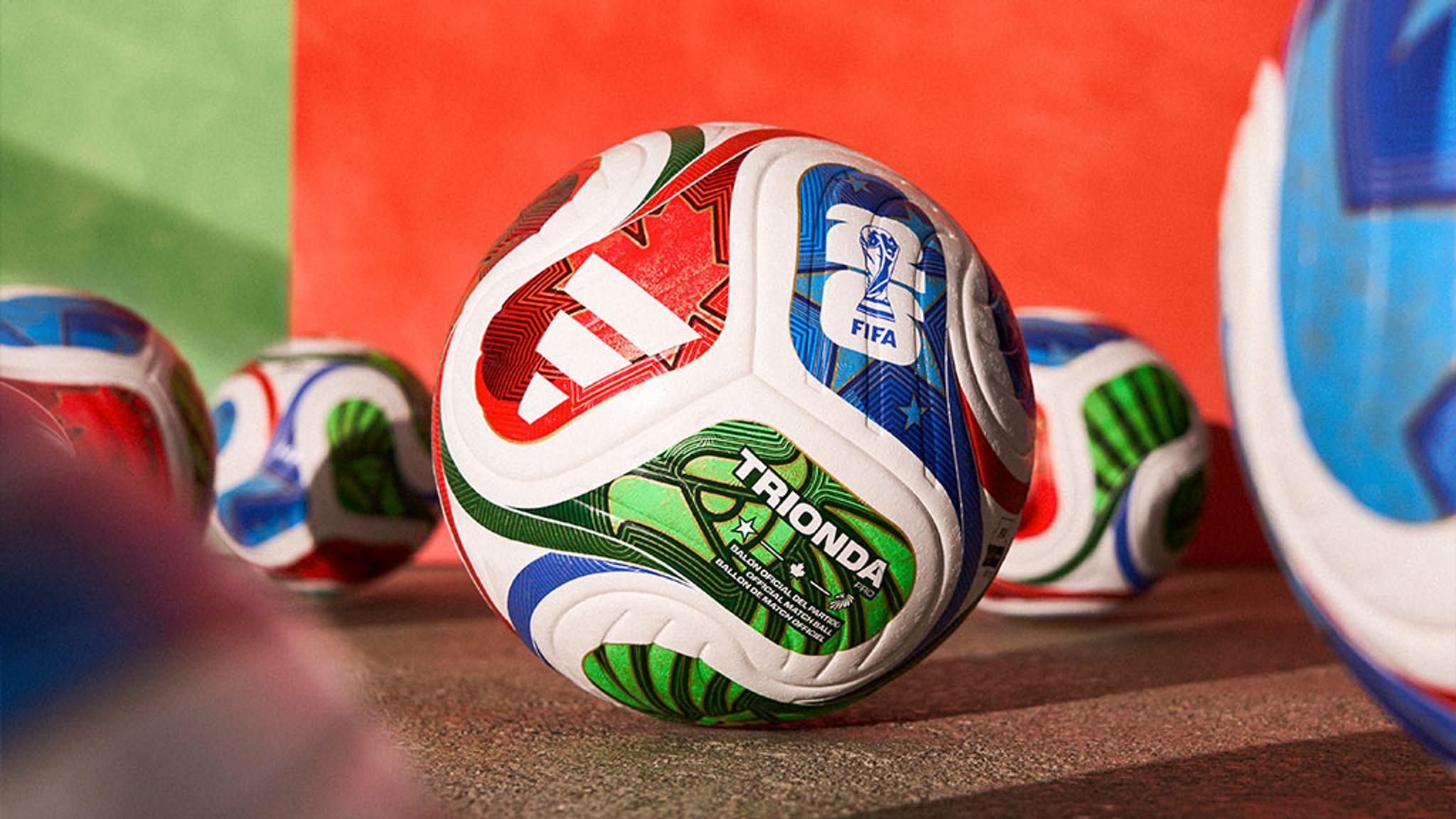 a soccer ball is sitting on top of a pile of other soccer balls .