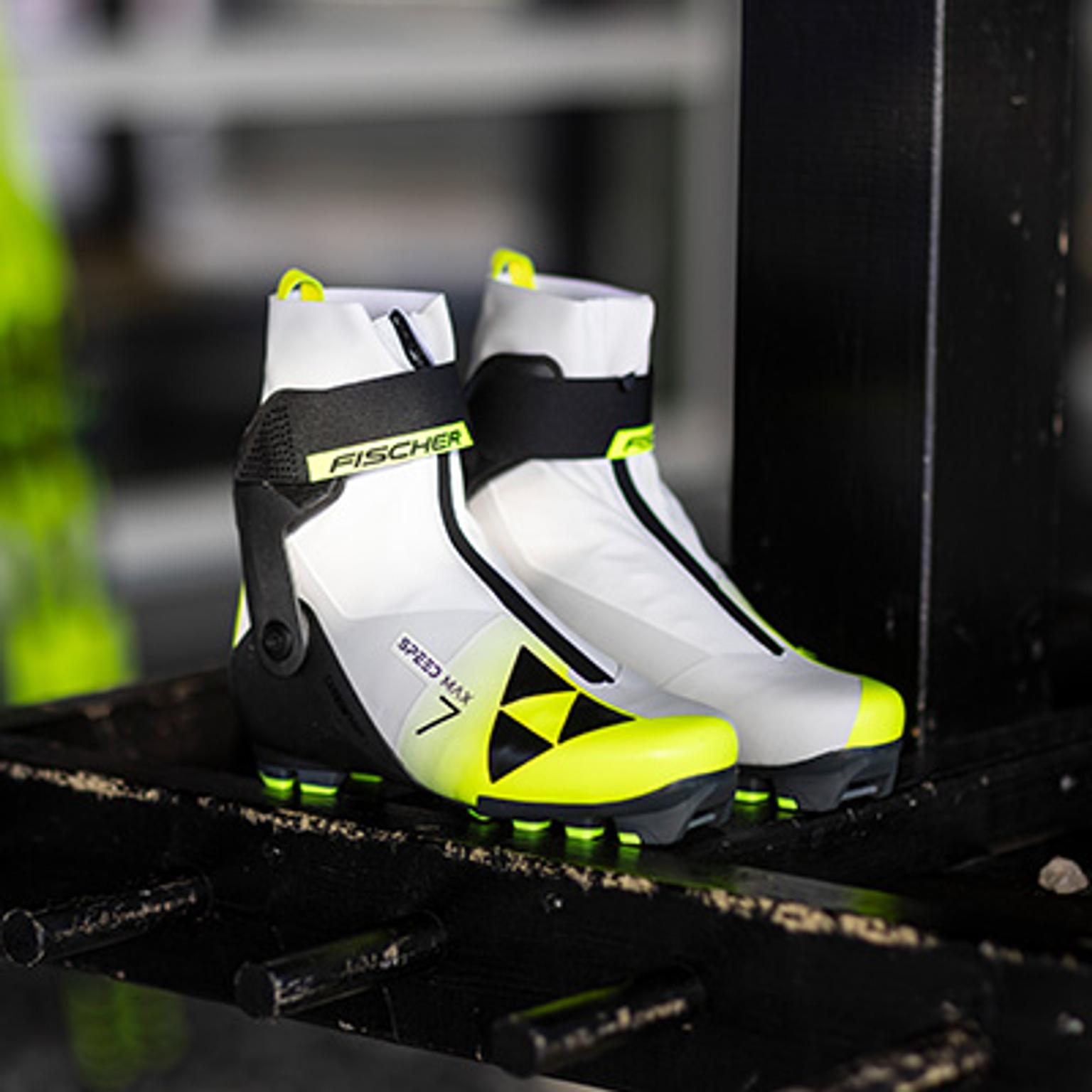 a pair of white and yellow skis are sitting on a shelf .