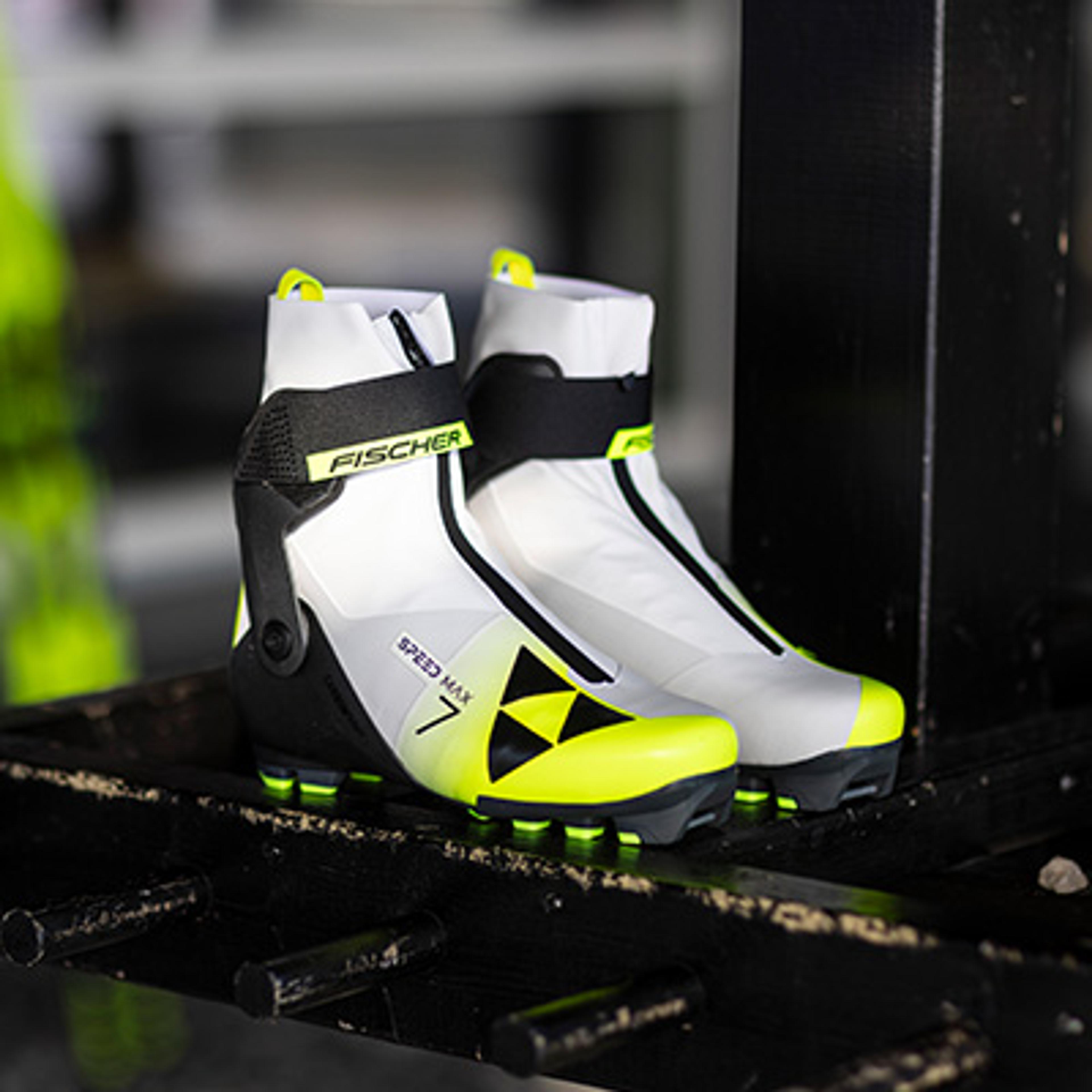 a pair of white and yellow skis are sitting on a shelf .