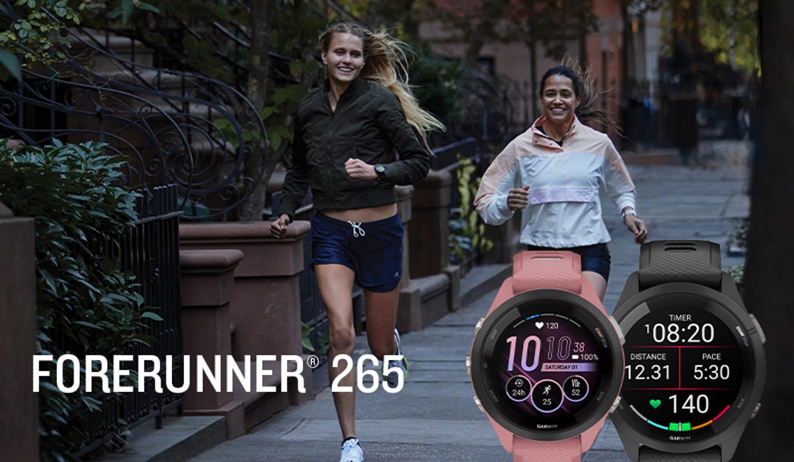 Two women running, with pink and black Forerunner 265 smartwatches displaying workout data in the foreground.