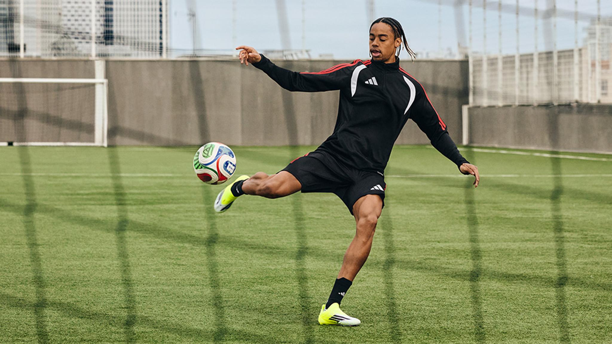 a close up of a person wearing soccer cleats on a field .