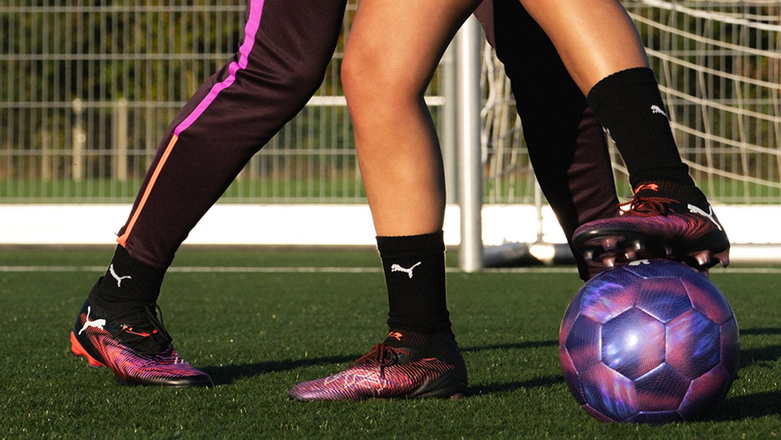 a couple of people are playing soccer on a field .