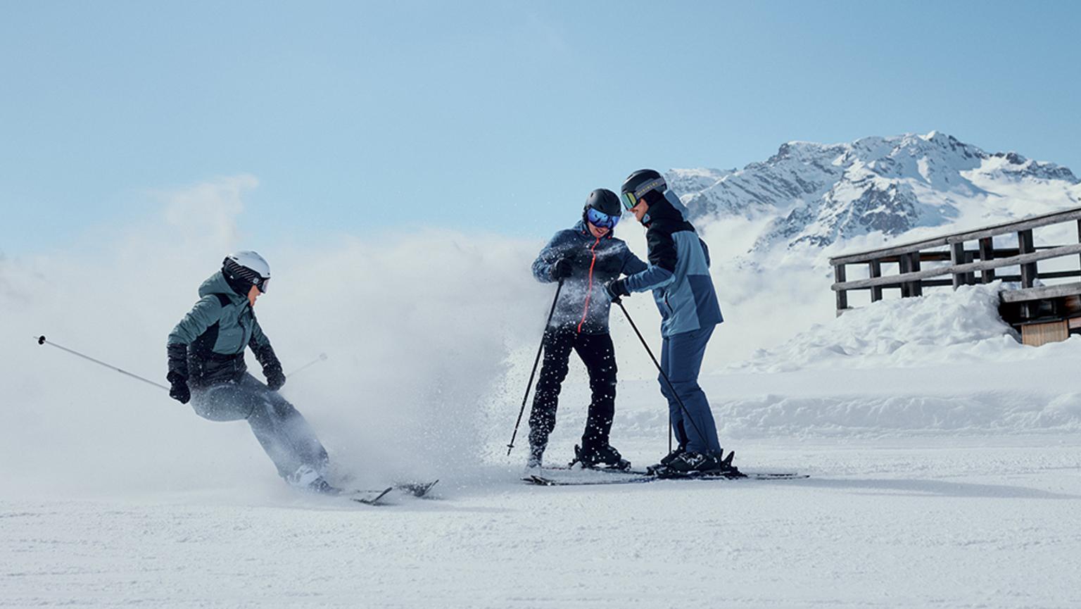 a group of people are skiing down a snow covered slope .