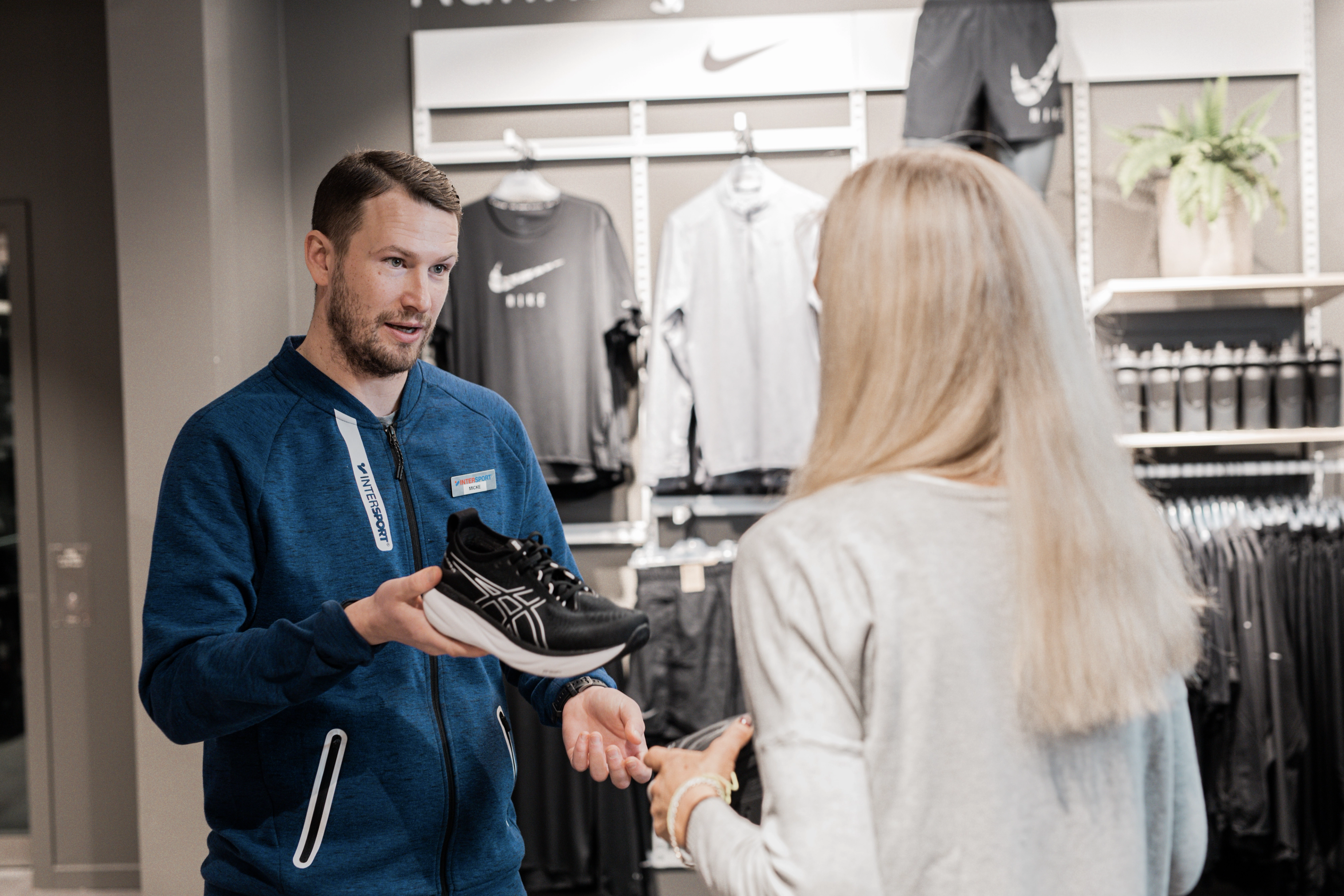 Five runners jogging in an urban environment.