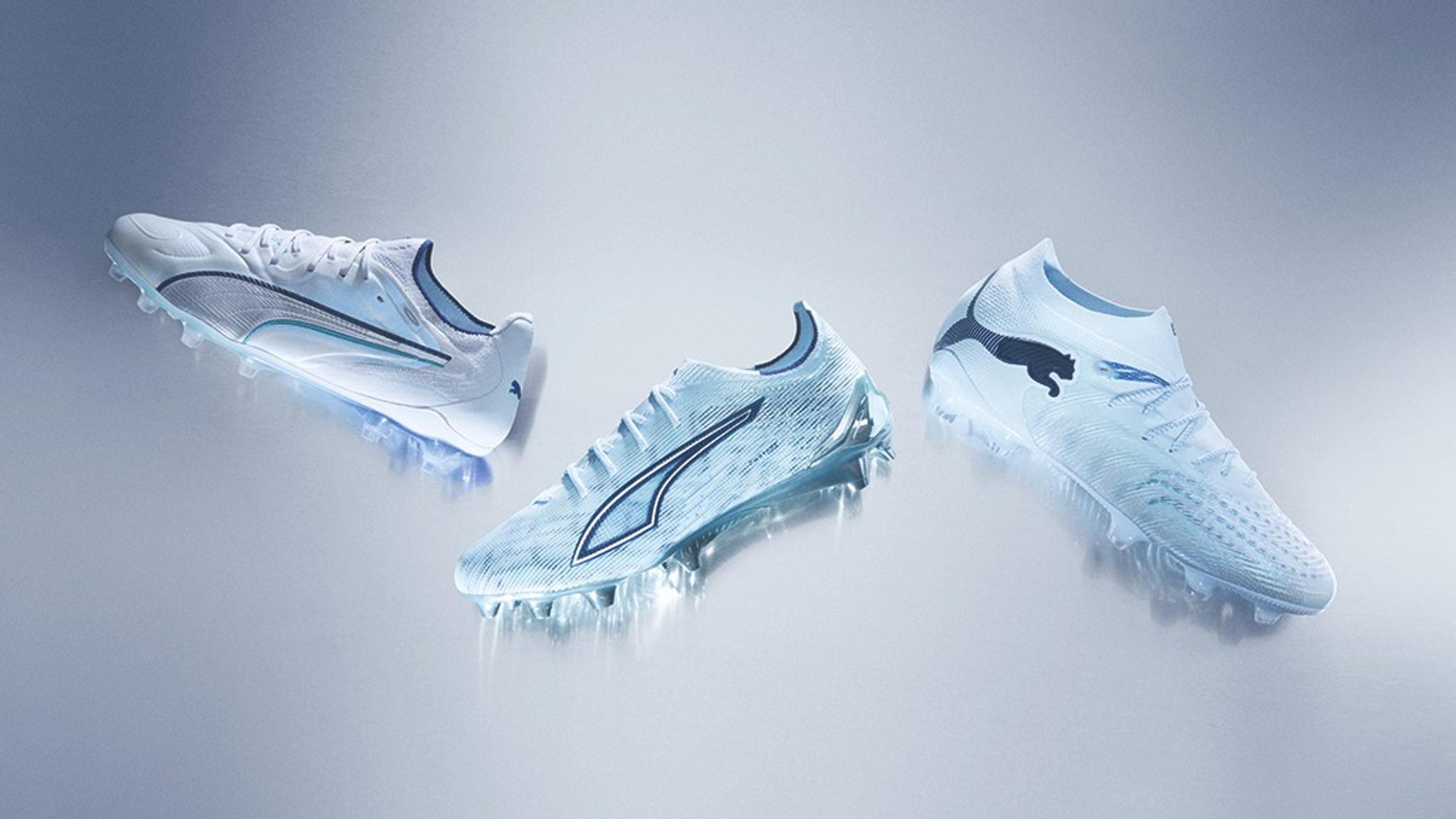 Three white and light blue Puma soccer cleats with an icy design on a light background.