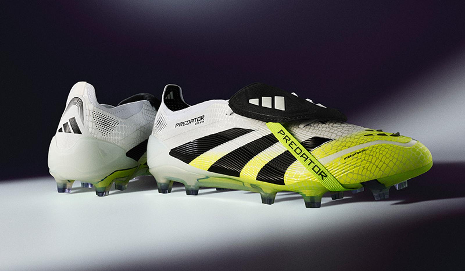 a pair of soccer cleats are sitting next to each other on a table .