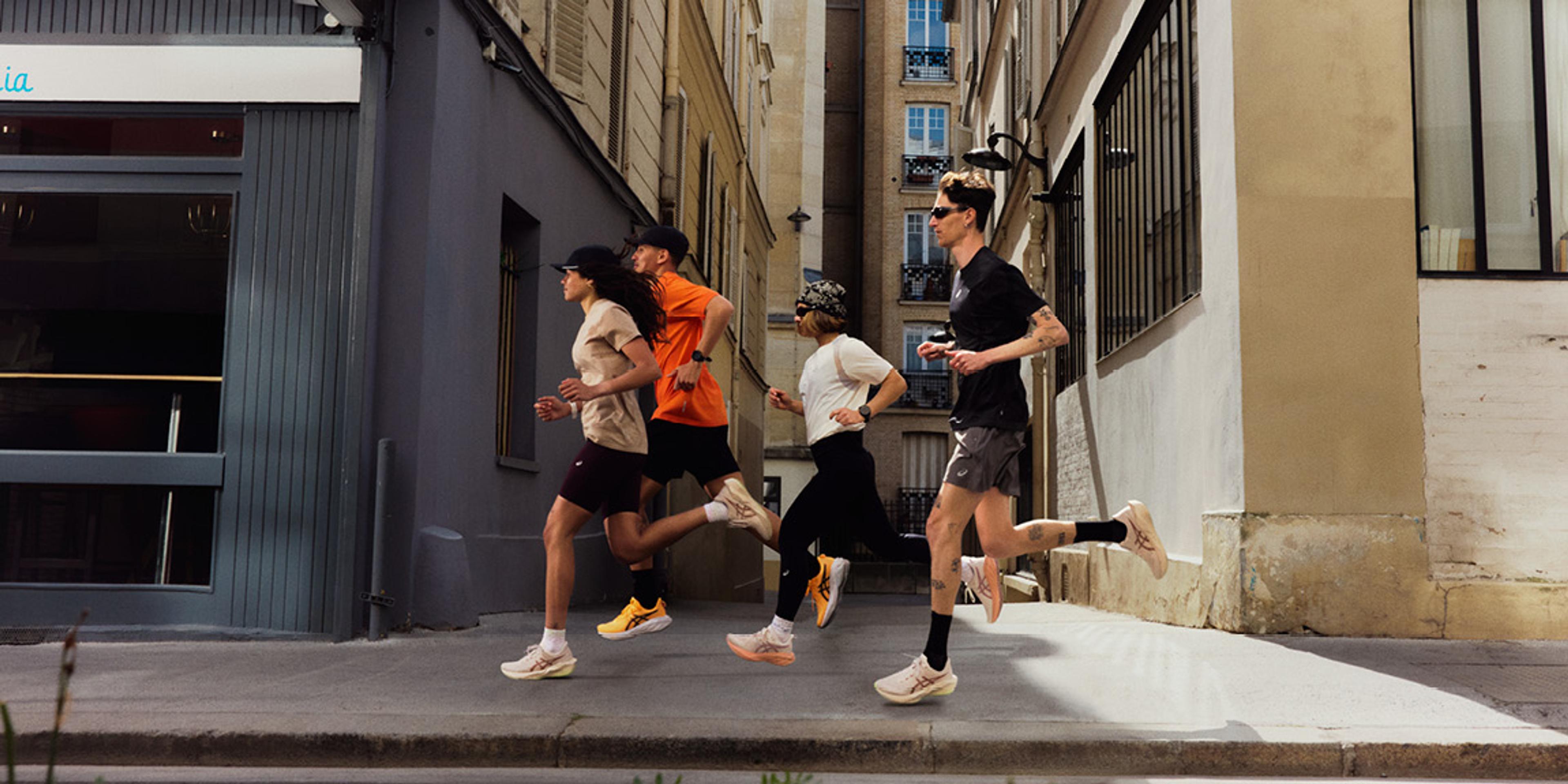 Four runners on a city street.