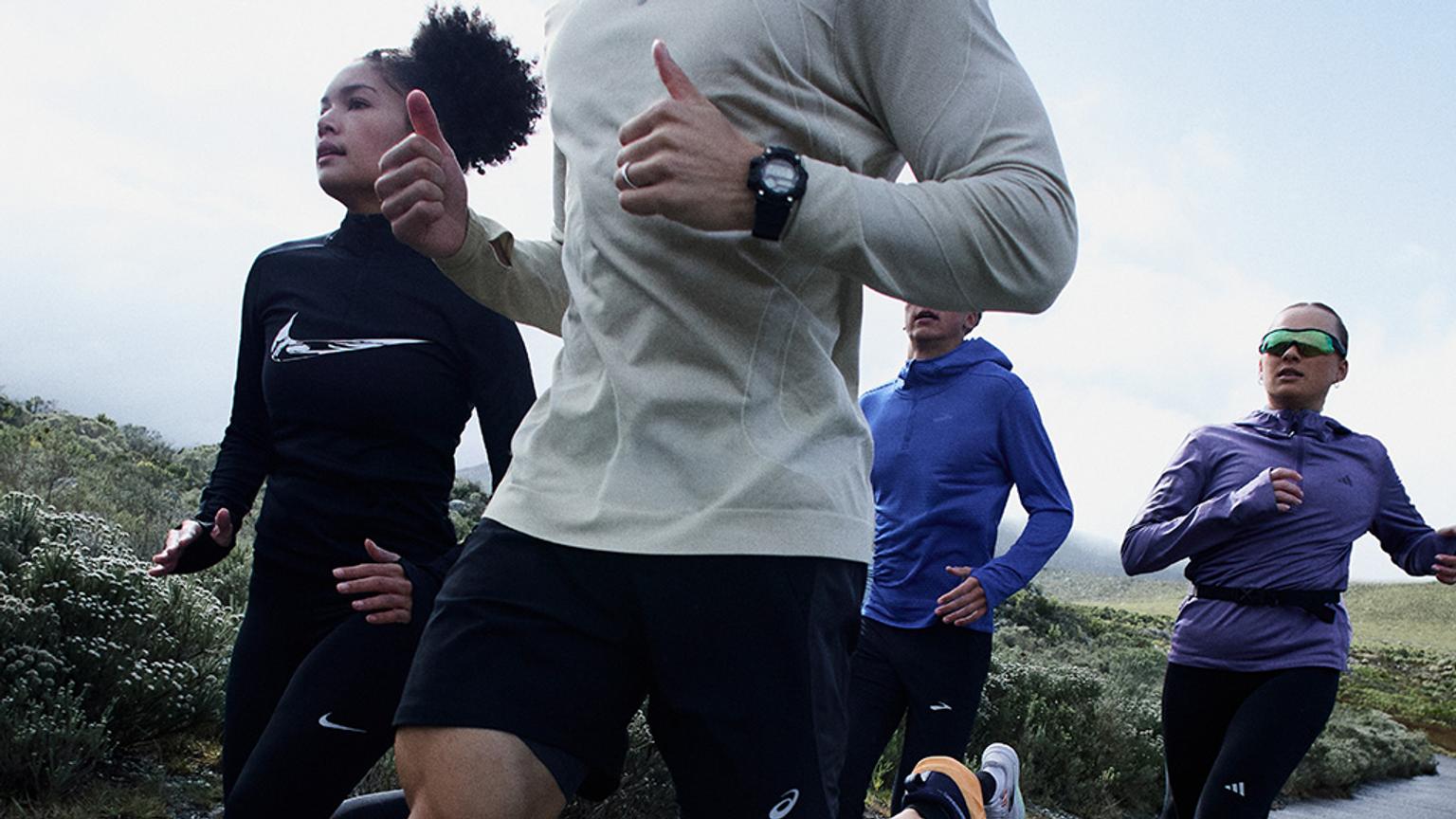 a group of people are running in a field .