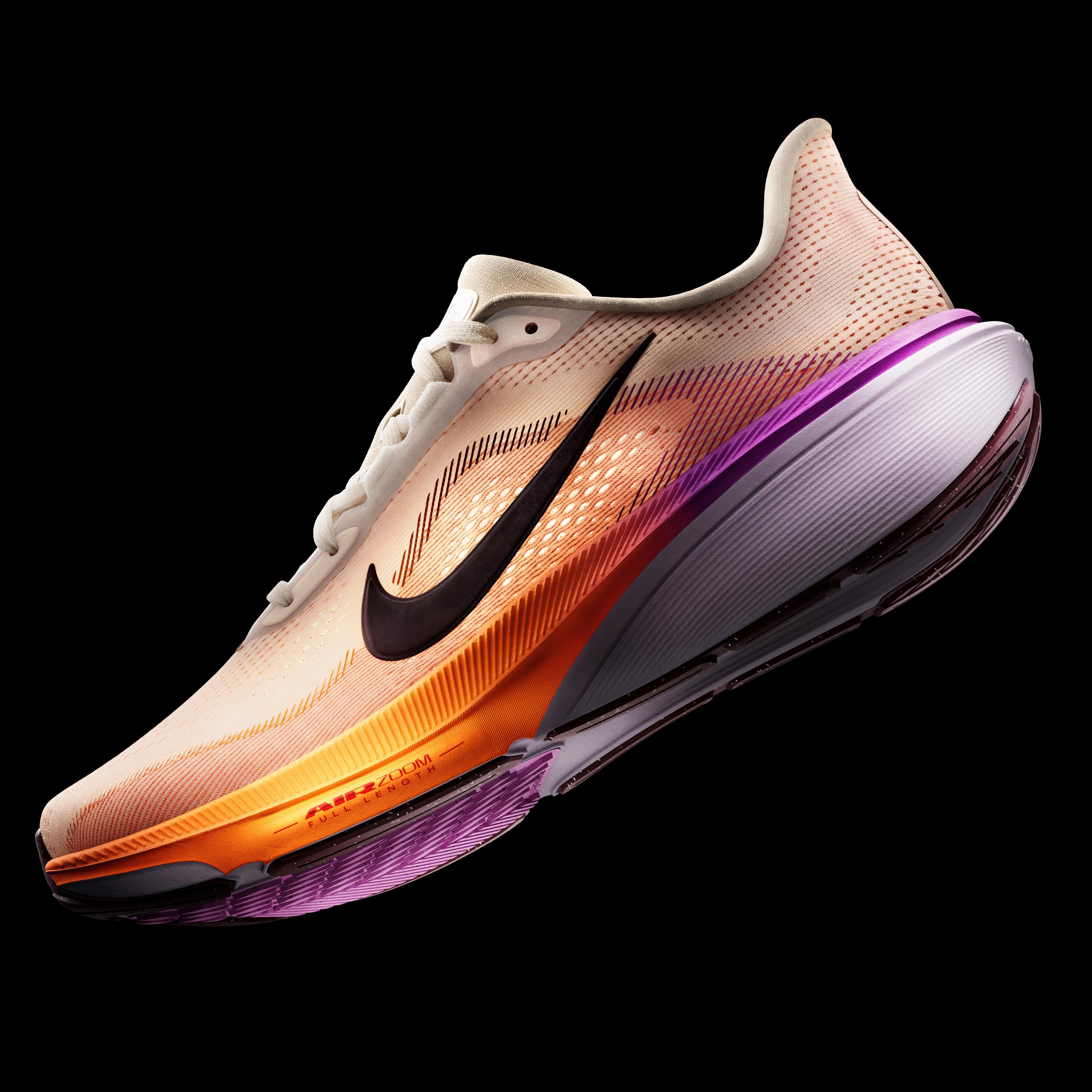 A Nike running shoe with a light tan upper, black swoosh, and an orange-to-purple gradient midsole.