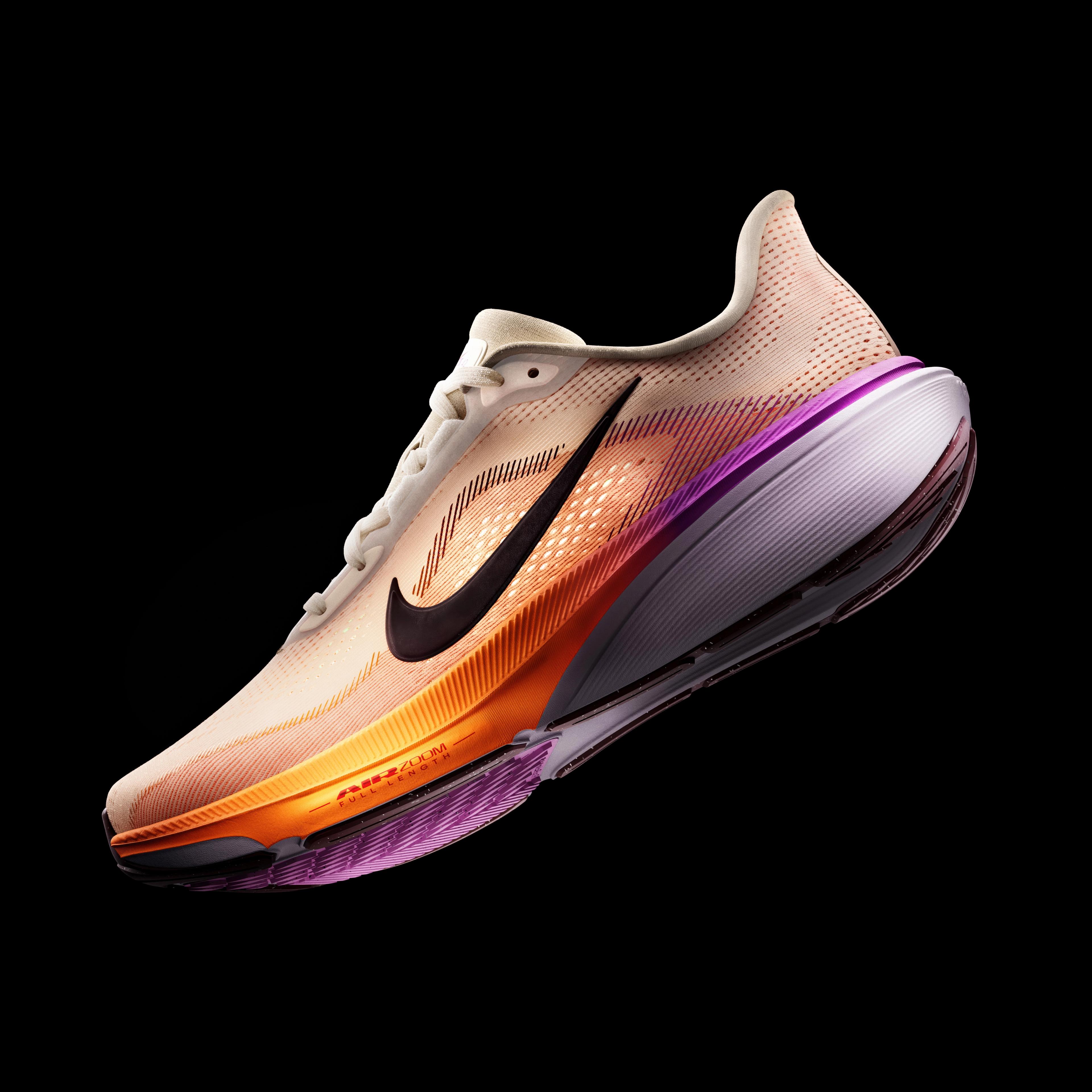 A multi-colored Nike running shoe with a beige upper, orange and purple sole, and black swoosh on a black background.