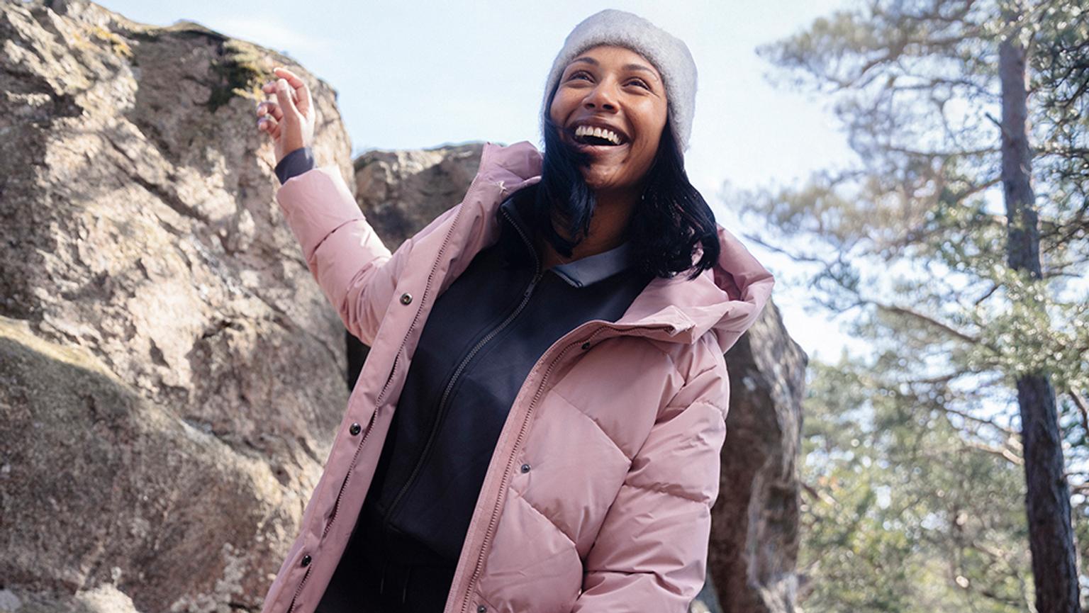 a woman in a white hat and jacket is getting out of a car .