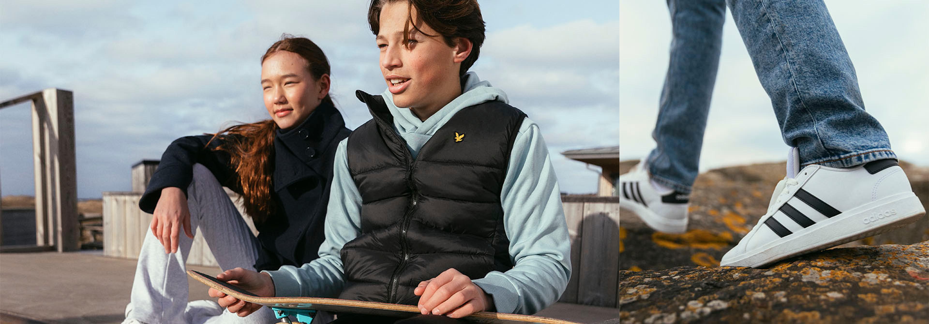 A composite image of a young man and woman with a skateboard, and a close-up of white Adidas sneakers on a rocky surface.