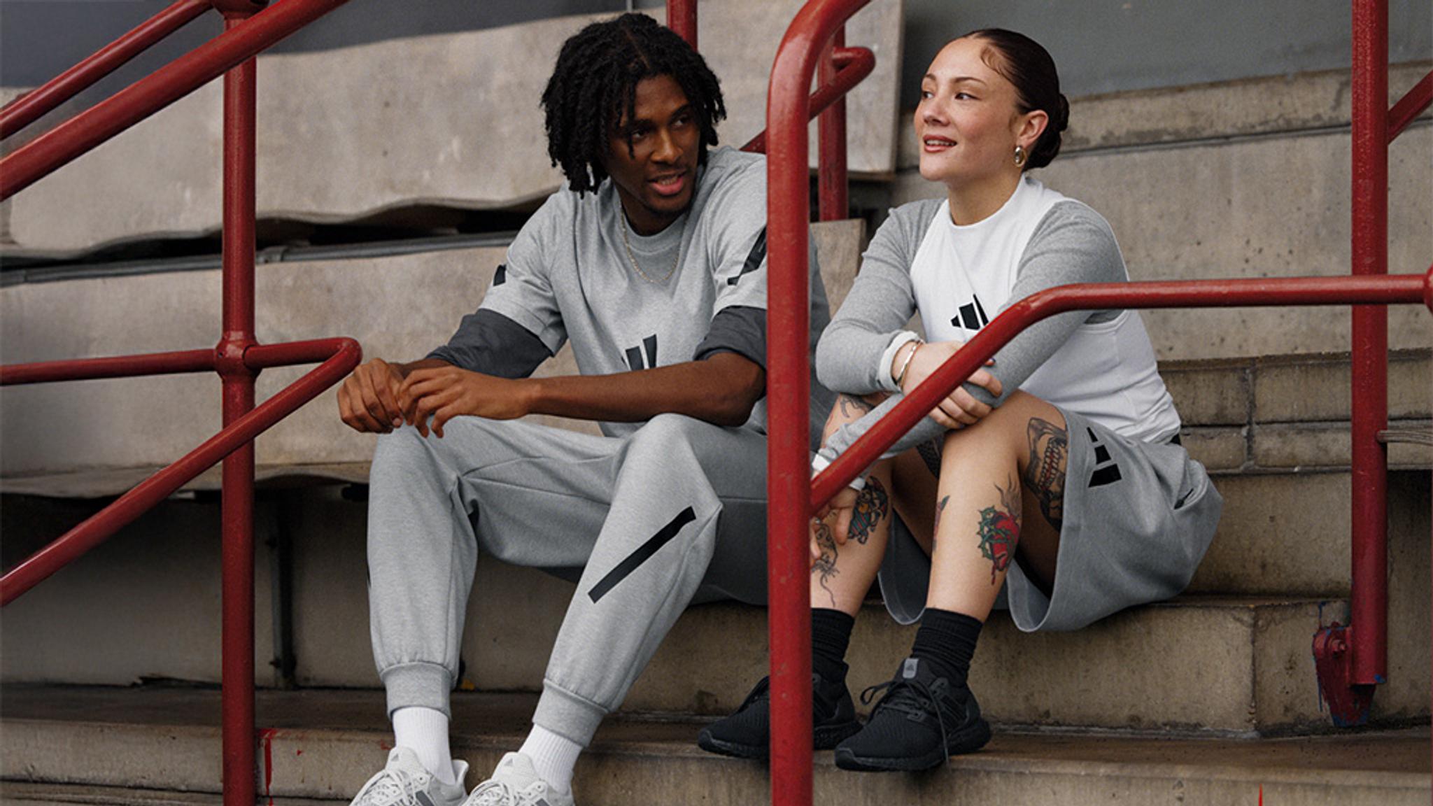 a man and a woman are sitting on a set of stairs .