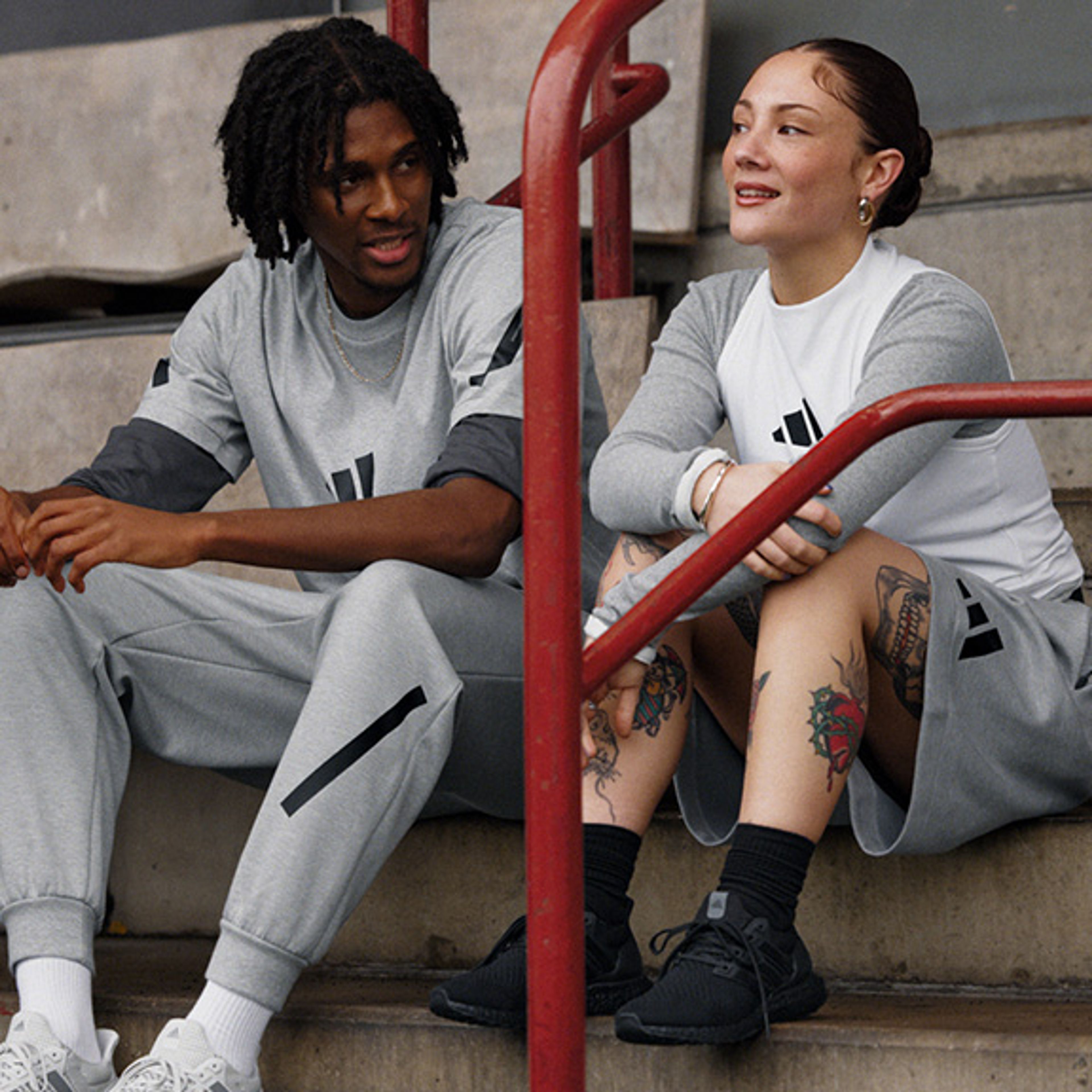 a man and a woman are sitting on a set of stairs .