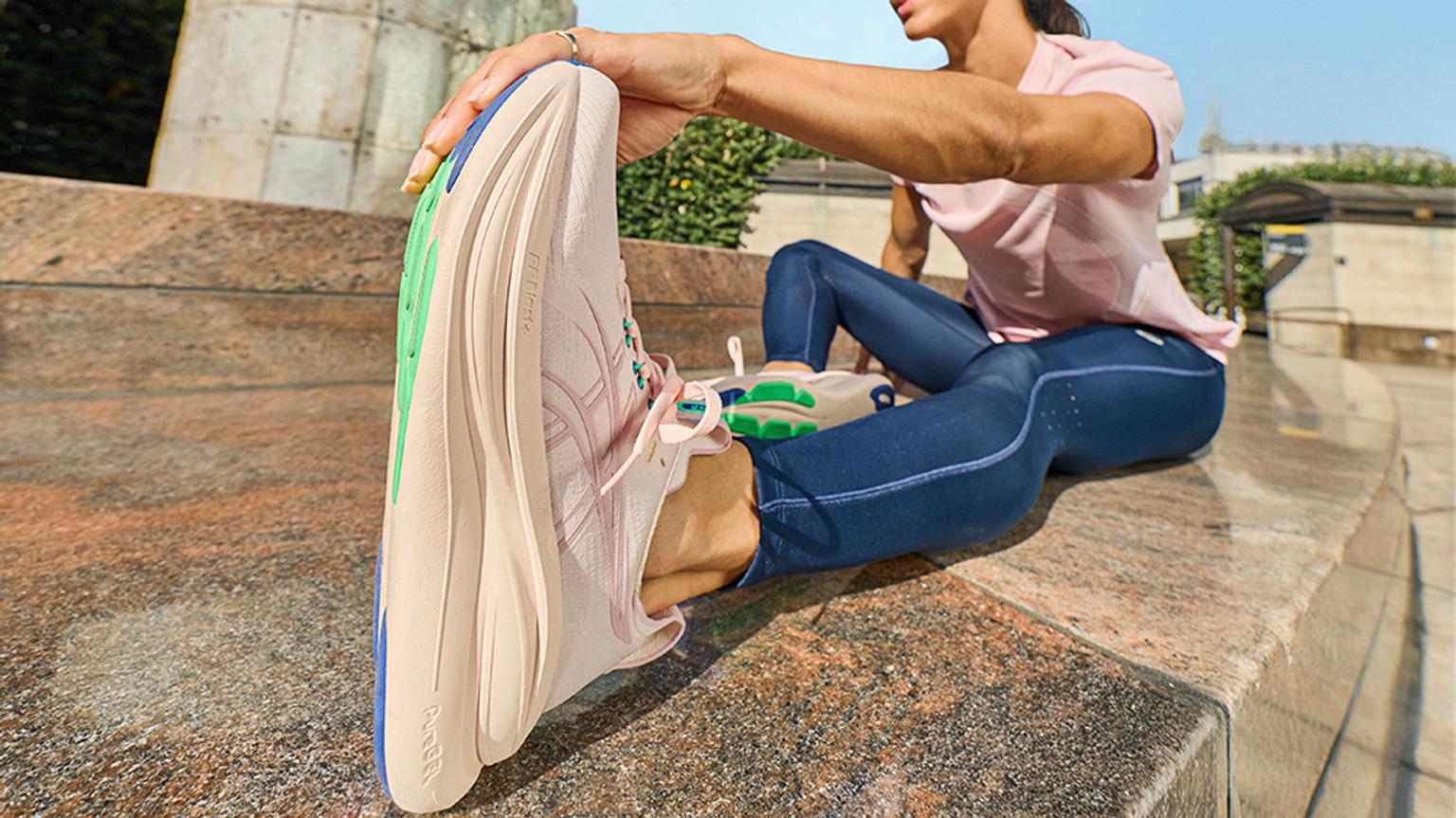 a man and a woman are running down a road .