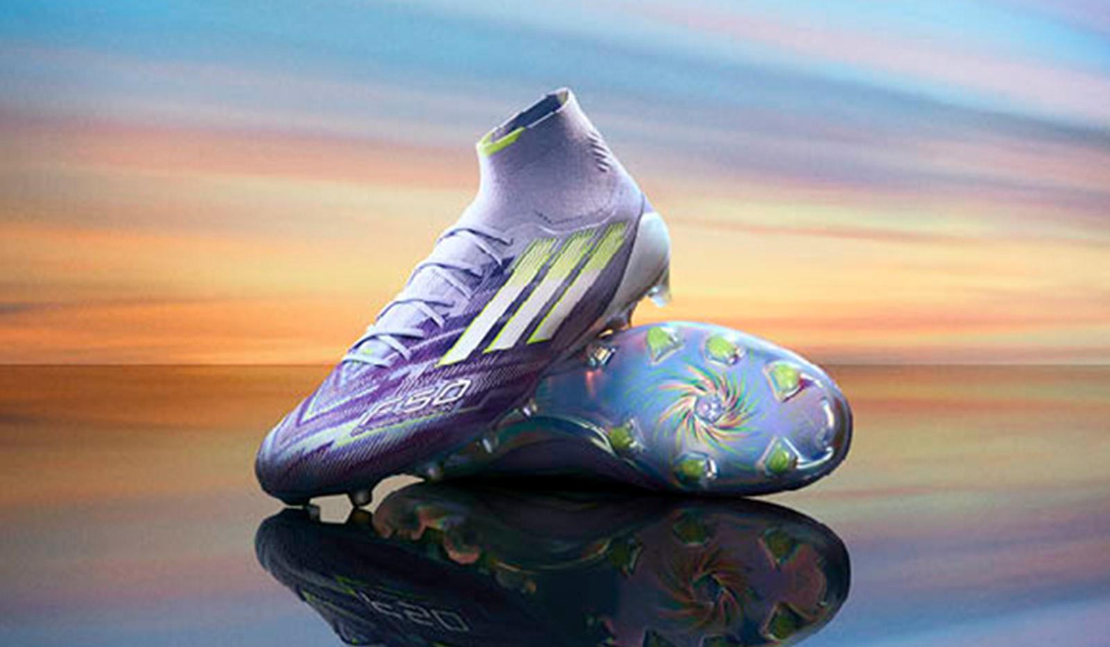 a pair of purple soccer cleats are sitting on top of each other on a table .