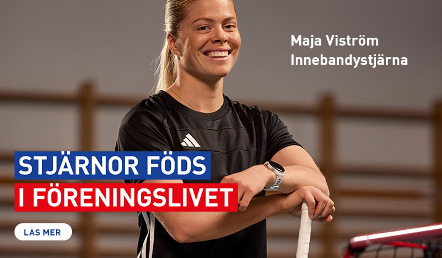 a woman in a black shirt is standing with her arms crossed and smiling .