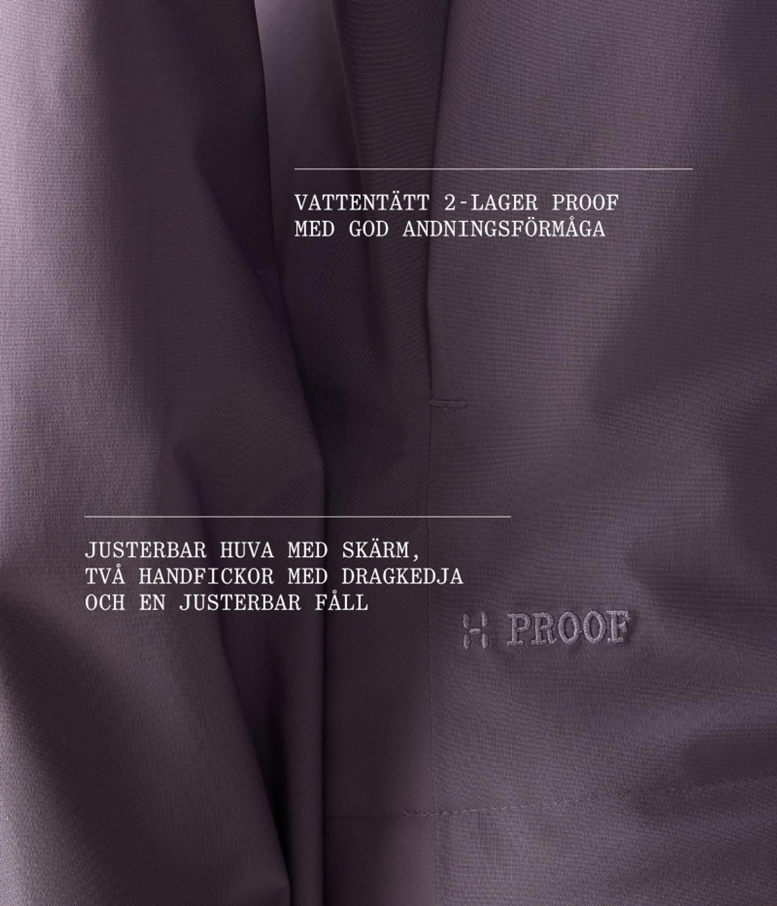 Close-up of dark purple fabric with white Swedish text describing a waterproof, breathable 2-layer material, adjustable hood, zippered pockets, and adjustable hem. An "H PROOF" logo is also visible.