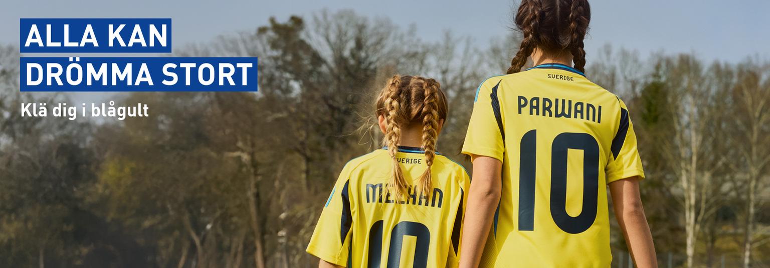 a woman and a child are holding hands and wearing yellow soccer jerseys .