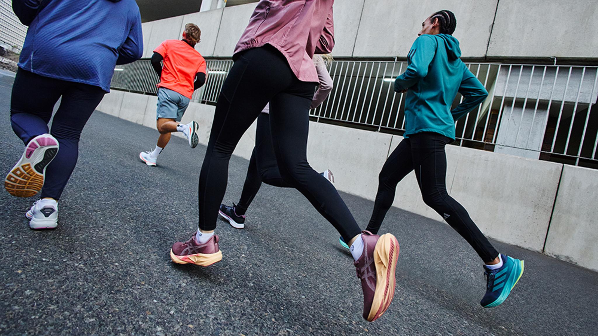 a group of people are running down a street in new shoes .
