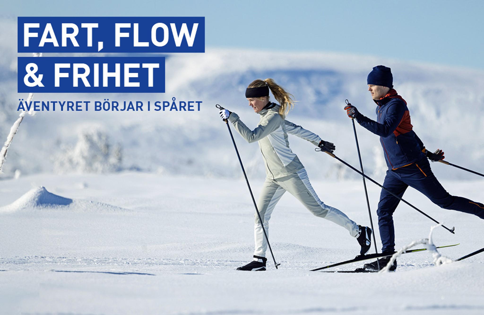 a man and a woman are cross country skiing in the snow .