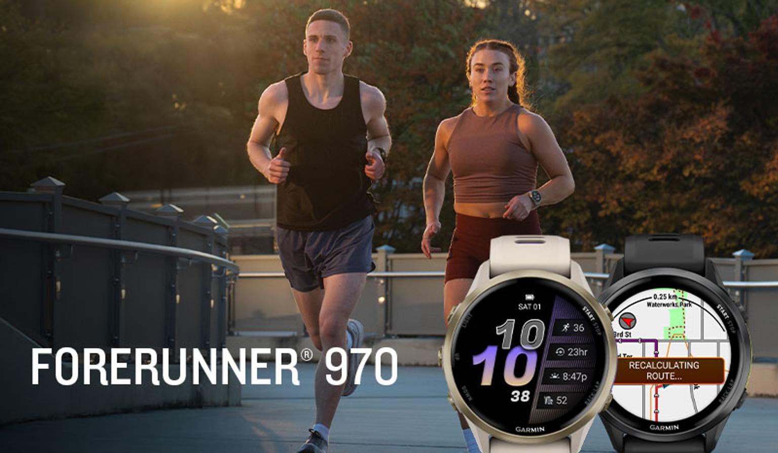 A man and woman running outdoors at sunset, with two Garmin Forerunner 970 smartwatches in the foreground.
