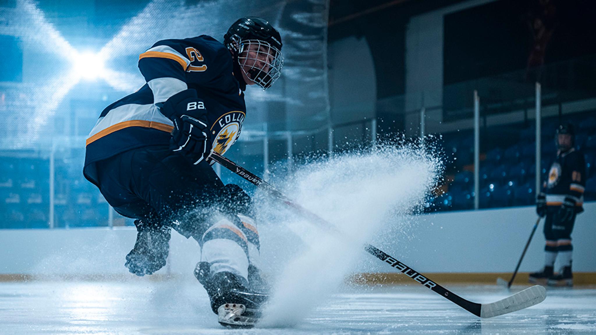 a hockey player is skating on the ice with a stick .