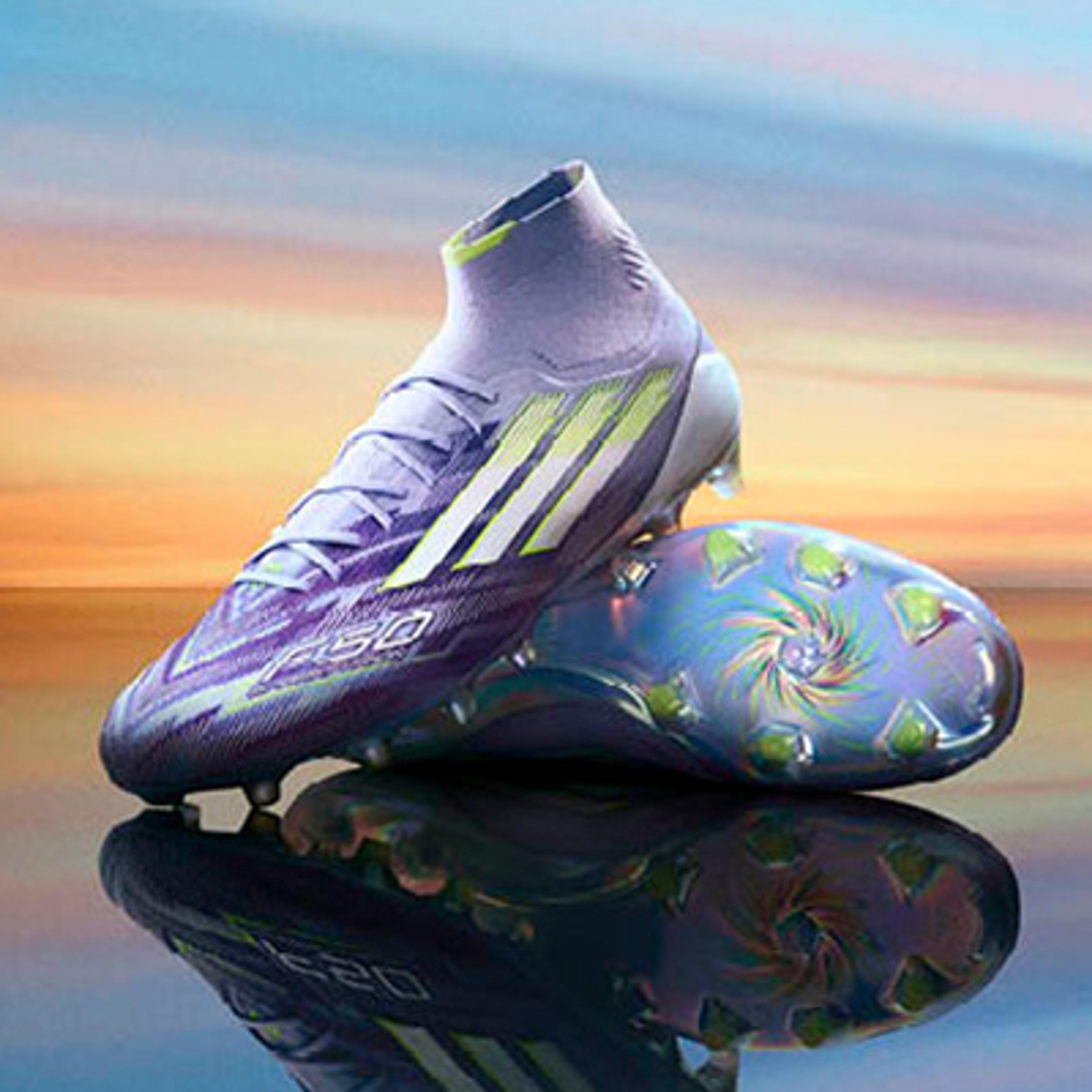 a pair of purple soccer cleats are sitting on top of each other on a table .