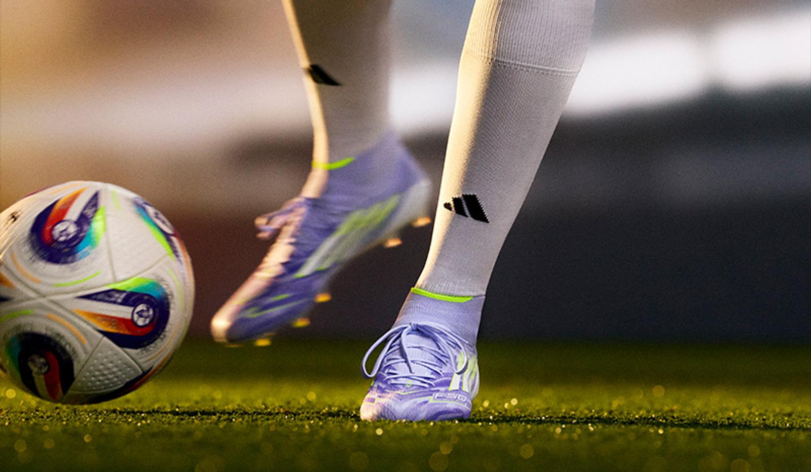 a person is kicking a soccer ball on a field .