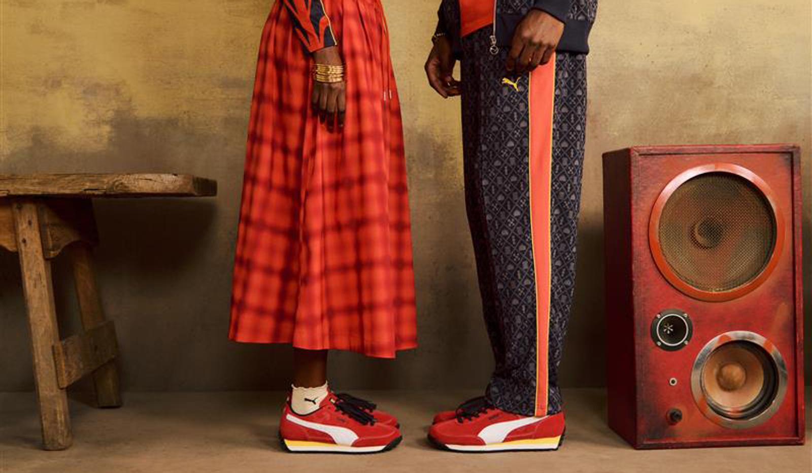 a man and a woman are standing next to each other in front of a speaker .