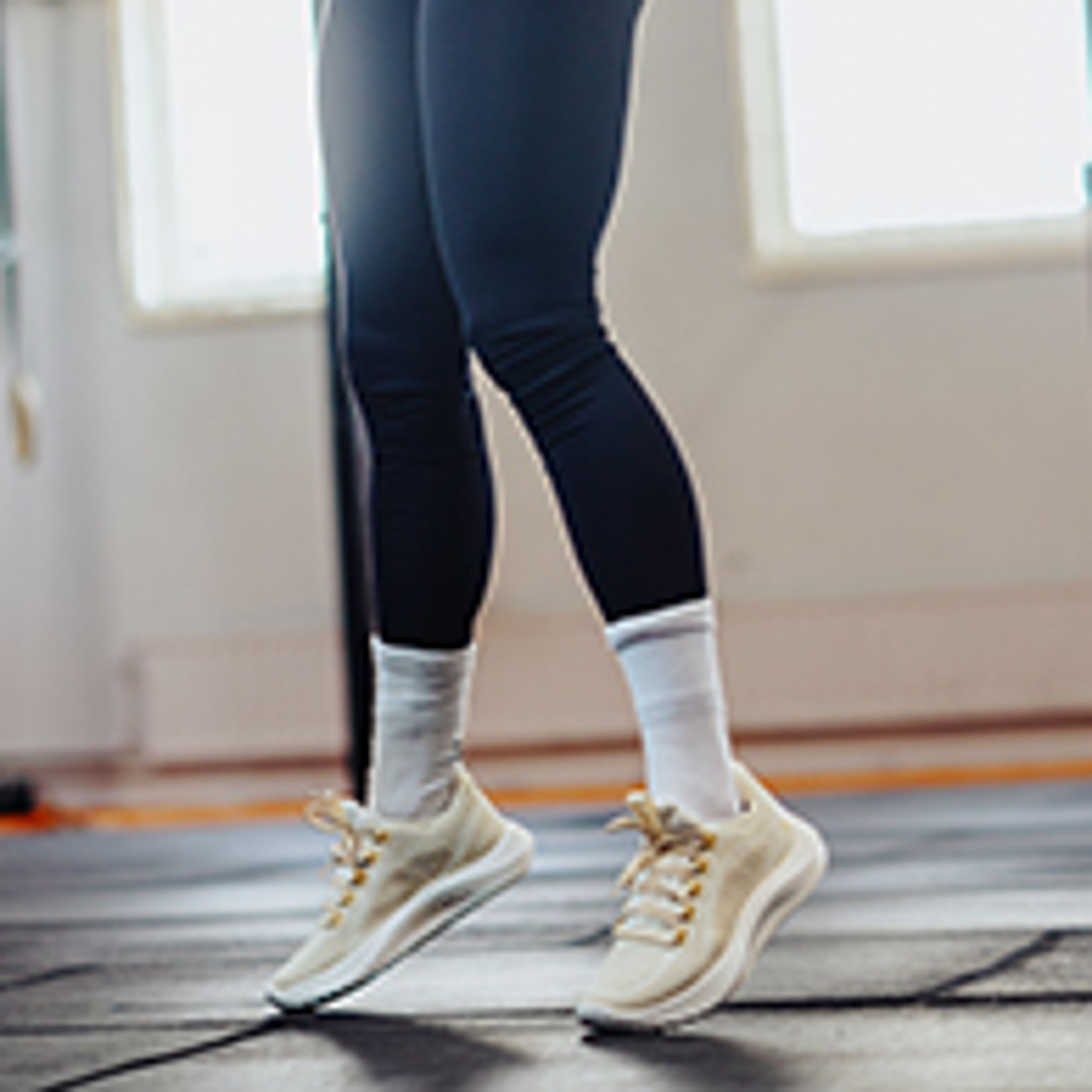 a woman is lifting a dumbbell in a gym .