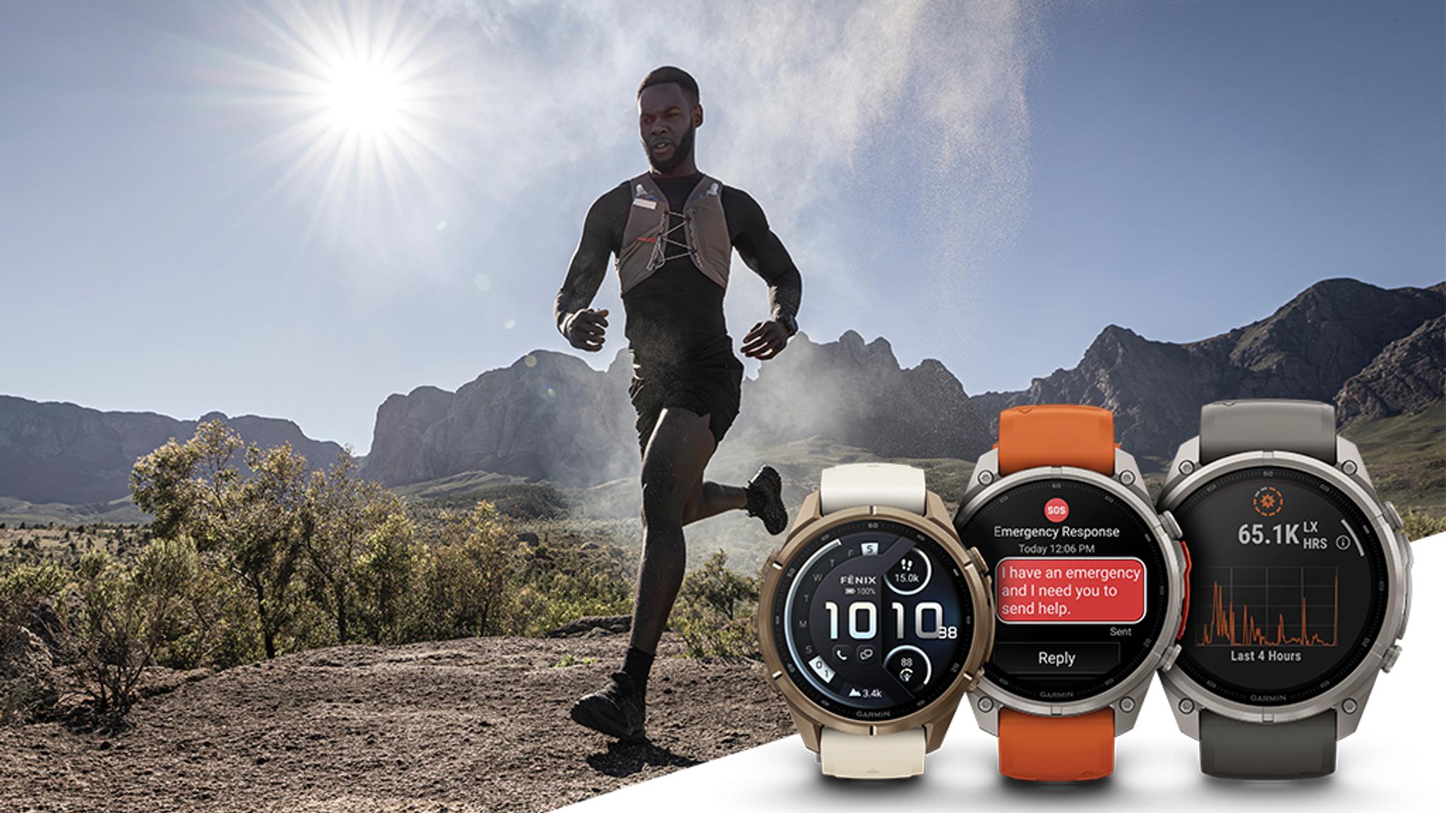 A man trail running on a sunny mountain path, with three Garmin smartwatches in the foreground displaying time, an emergency message, and activity data.