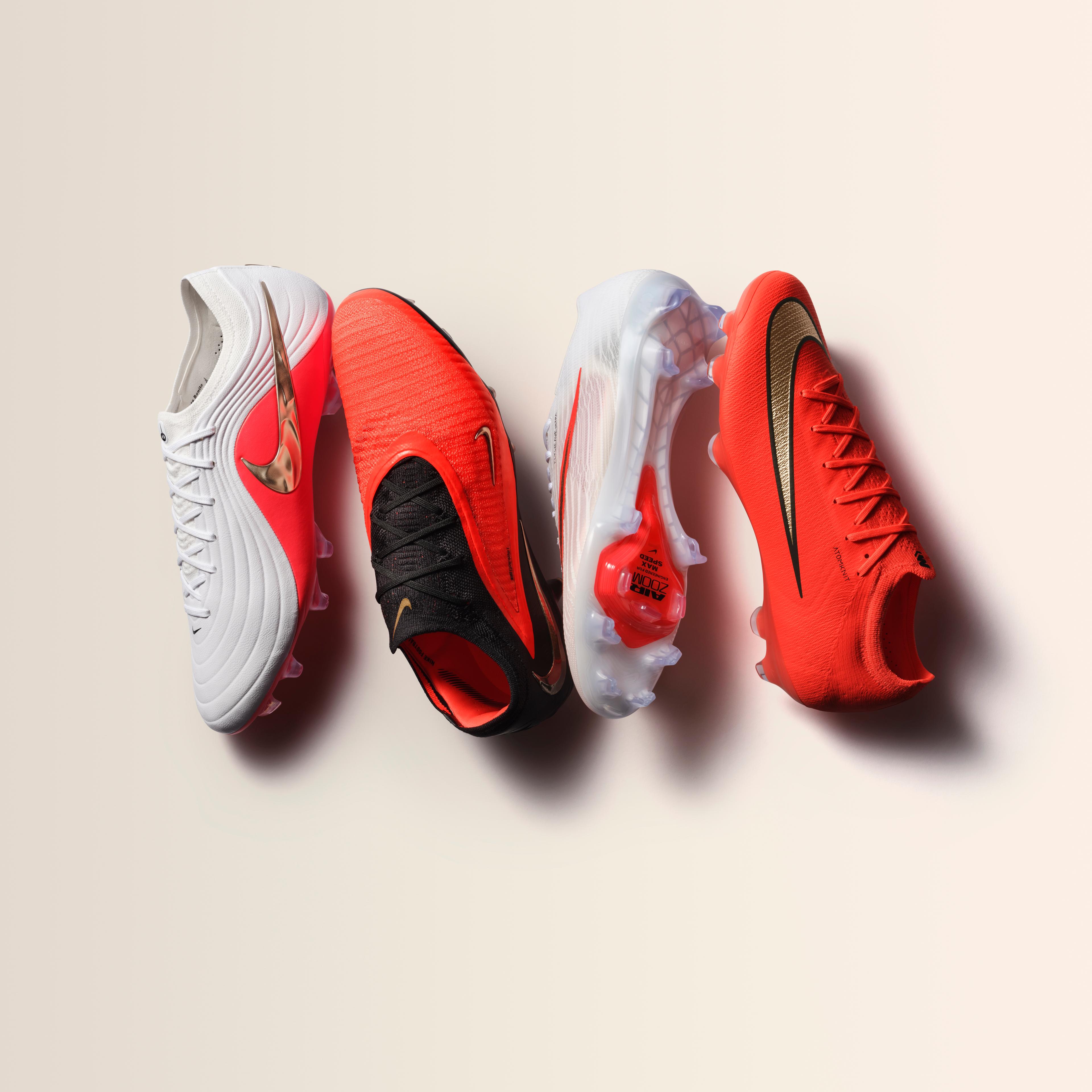 Four Nike soccer cleats in white, orange, and gold.