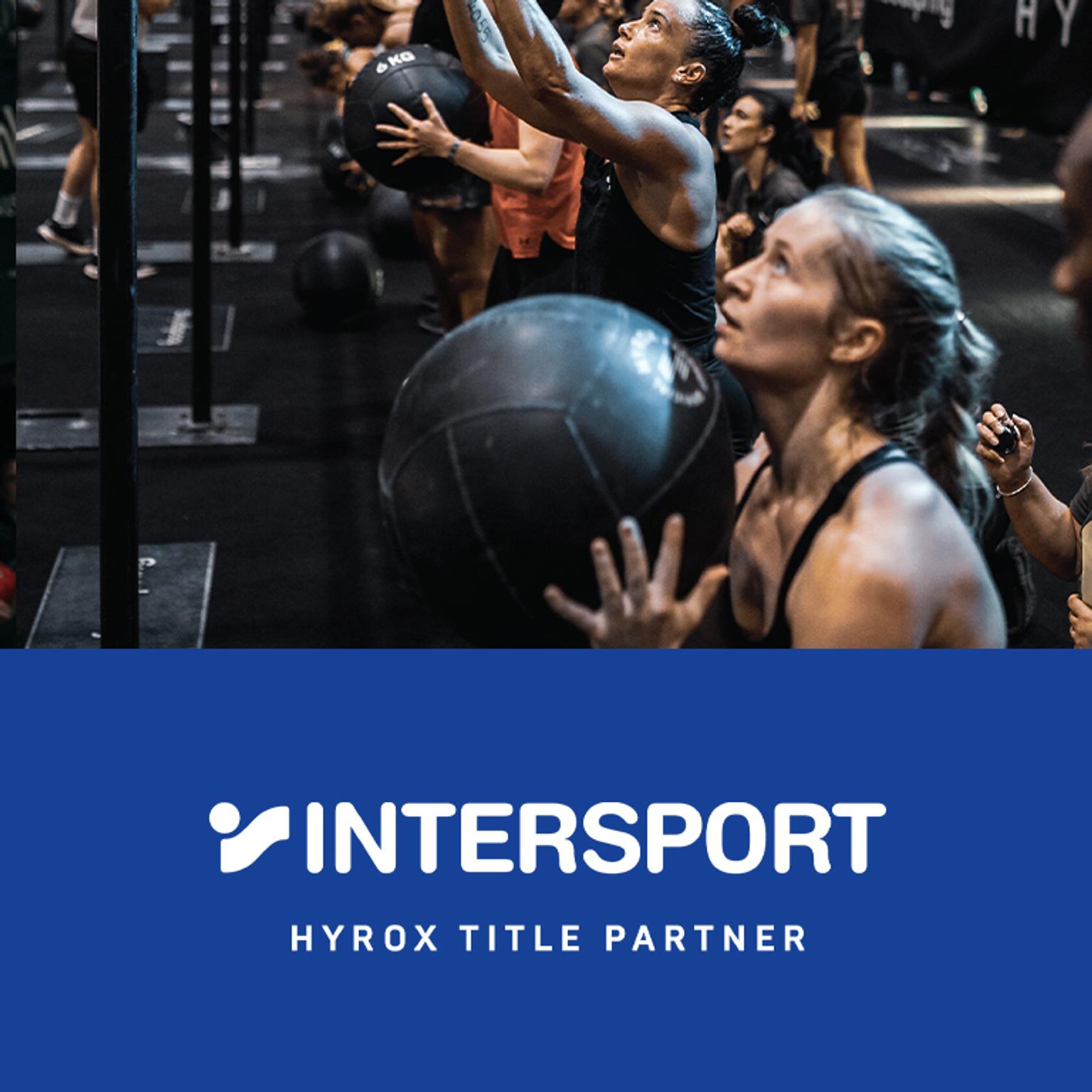 a group of women are holding medicine balls in a gym .