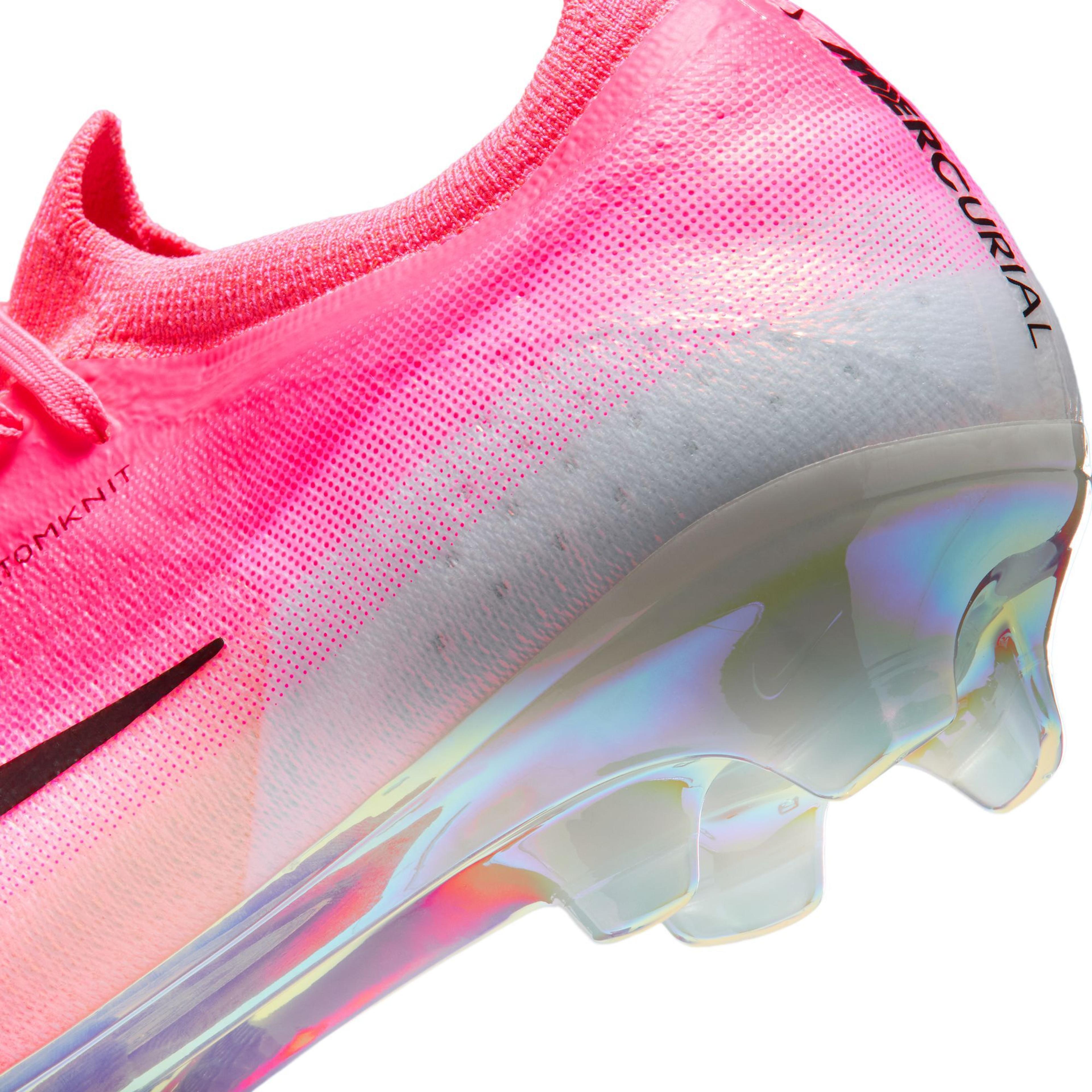 Close-up of a Nike Mercurial soccer cleat with a pink to white gradient upper and an iridescent sole.