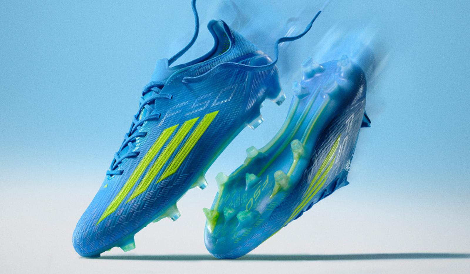 Two blue and neon yellow Adidas F50 soccer cleats with motion blur on a light blue background.