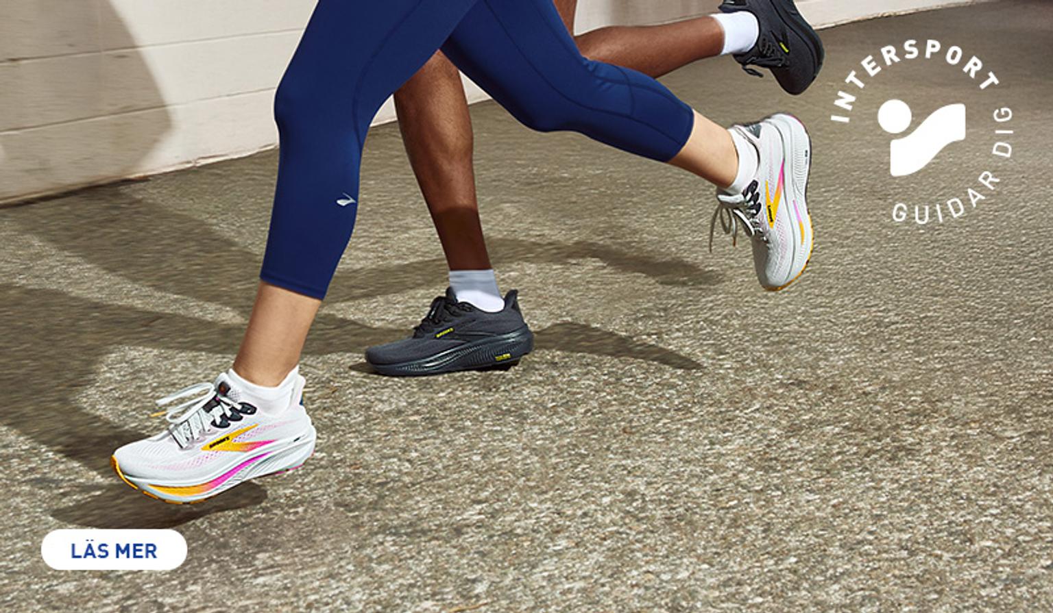 a man and a woman are running on a sidewalk .