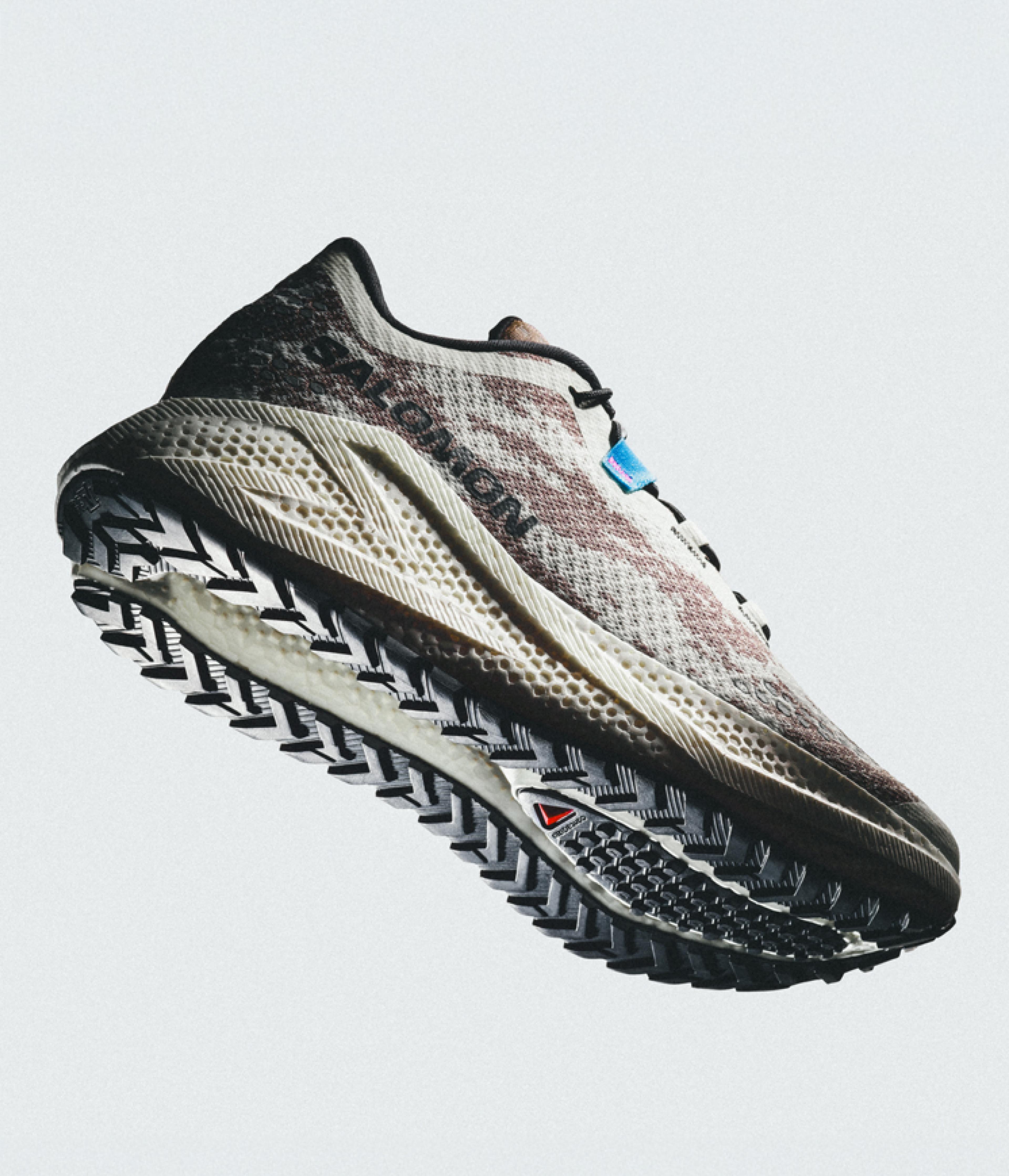 Salomon trail running shoe with a patterned upper and aggressive lugged outsole.